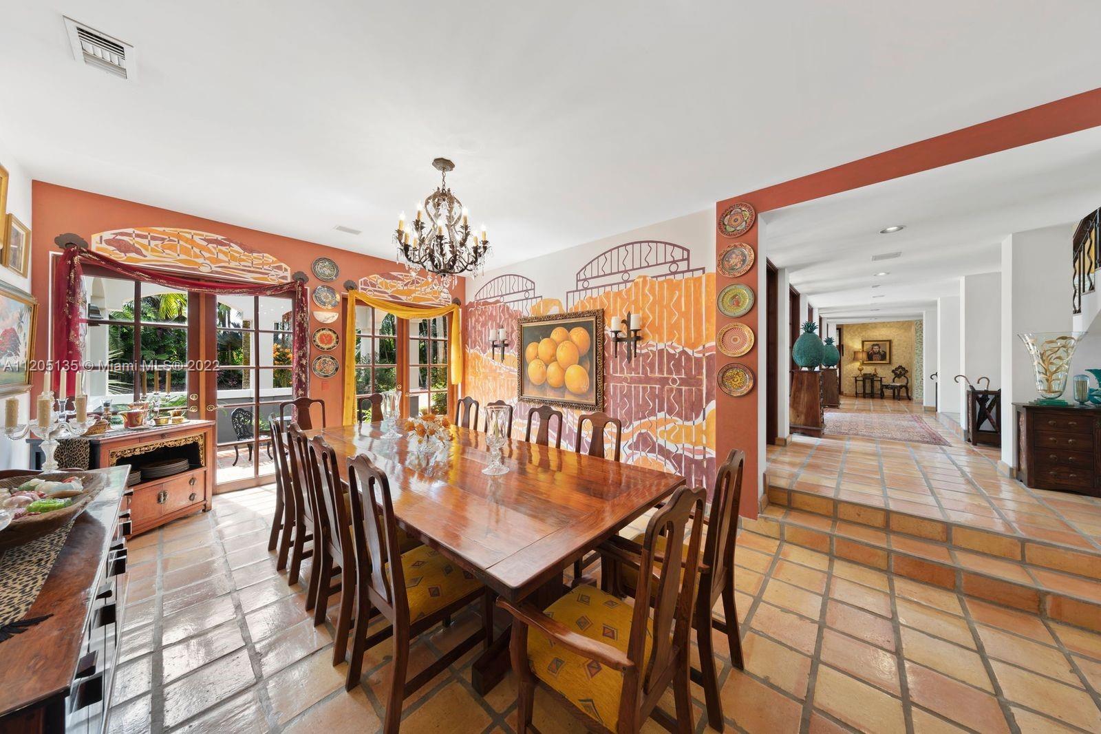 Formal Dining opens to a private courtyard...unseen is the wine cabinet. The mural is spectacular w gold leafing thru out. The lines in the mural mimic the wine cabinet signature ironwork.