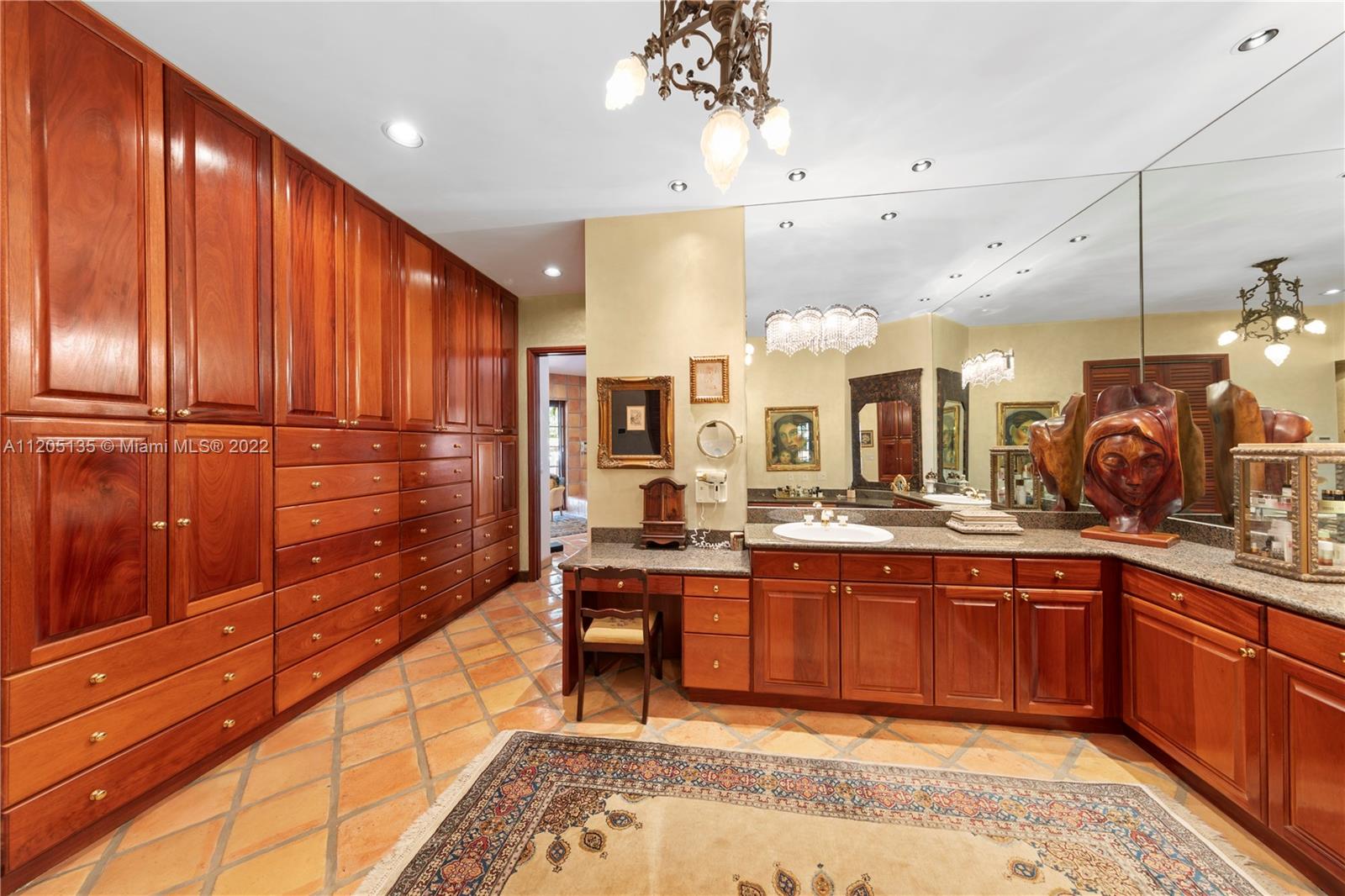 Floor to ceiling built in cabinetry in dressing area with multiple walk in closets (not shown in photos)