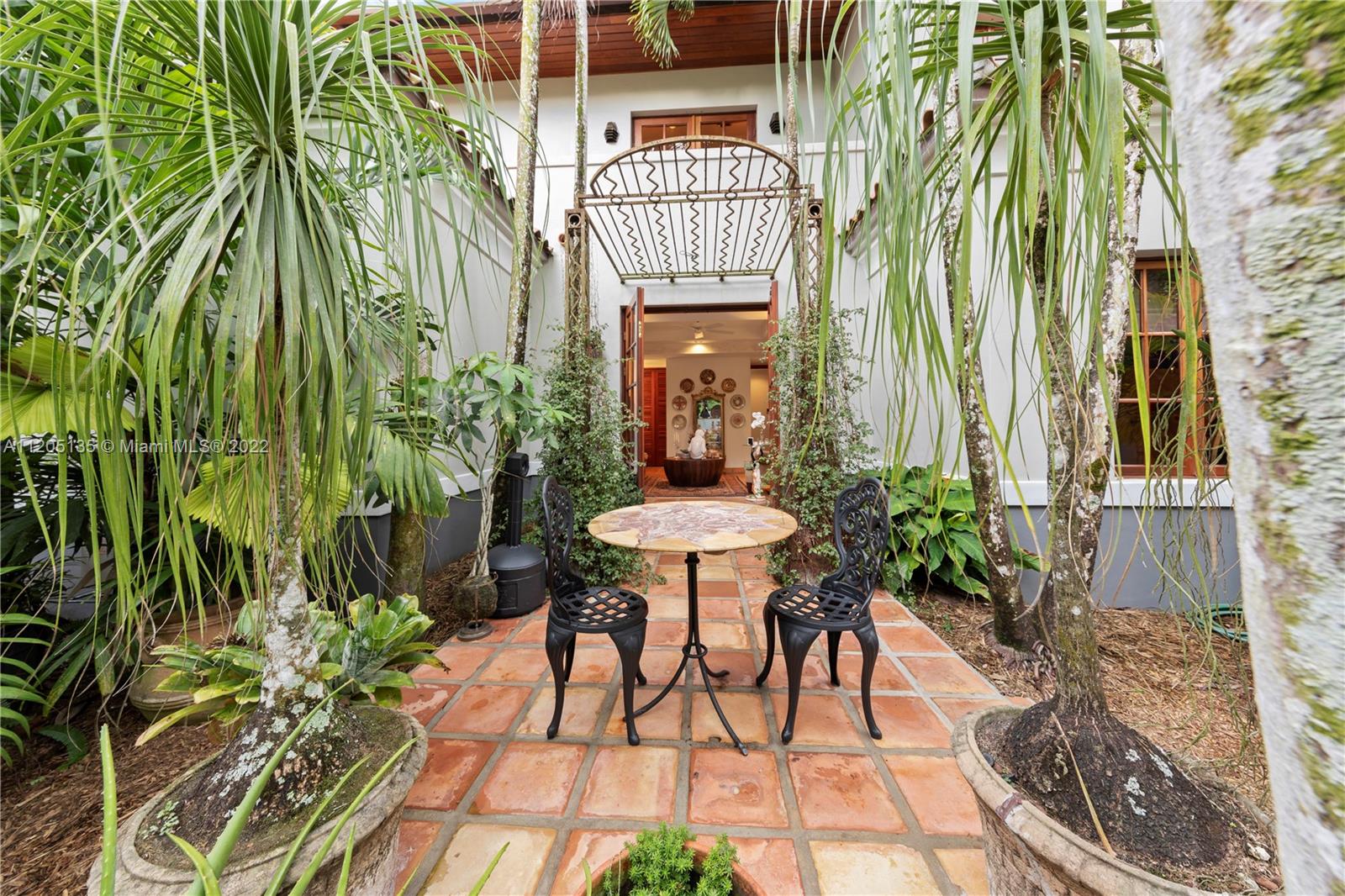 The guest suite's private patio/courtyard completely walled in with lush landscaping and privacy.