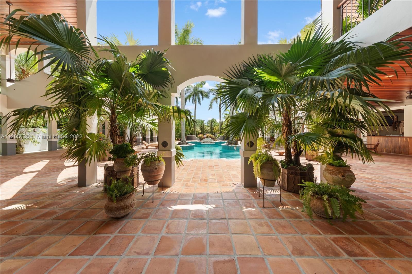 Leaving the great room to view the exterior living areas that surround the pool/spa. All exterior is adorned by floor to ceiling French windows, 100 poured concrete columns and volume archways.