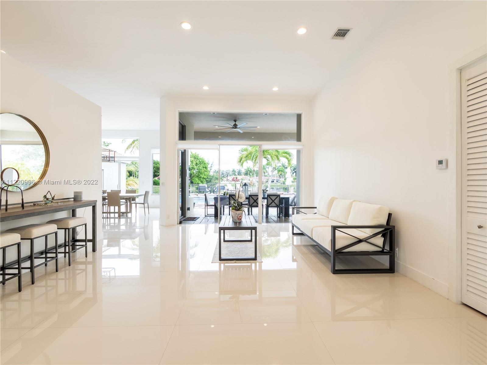 Living room area overlooking pool and lake