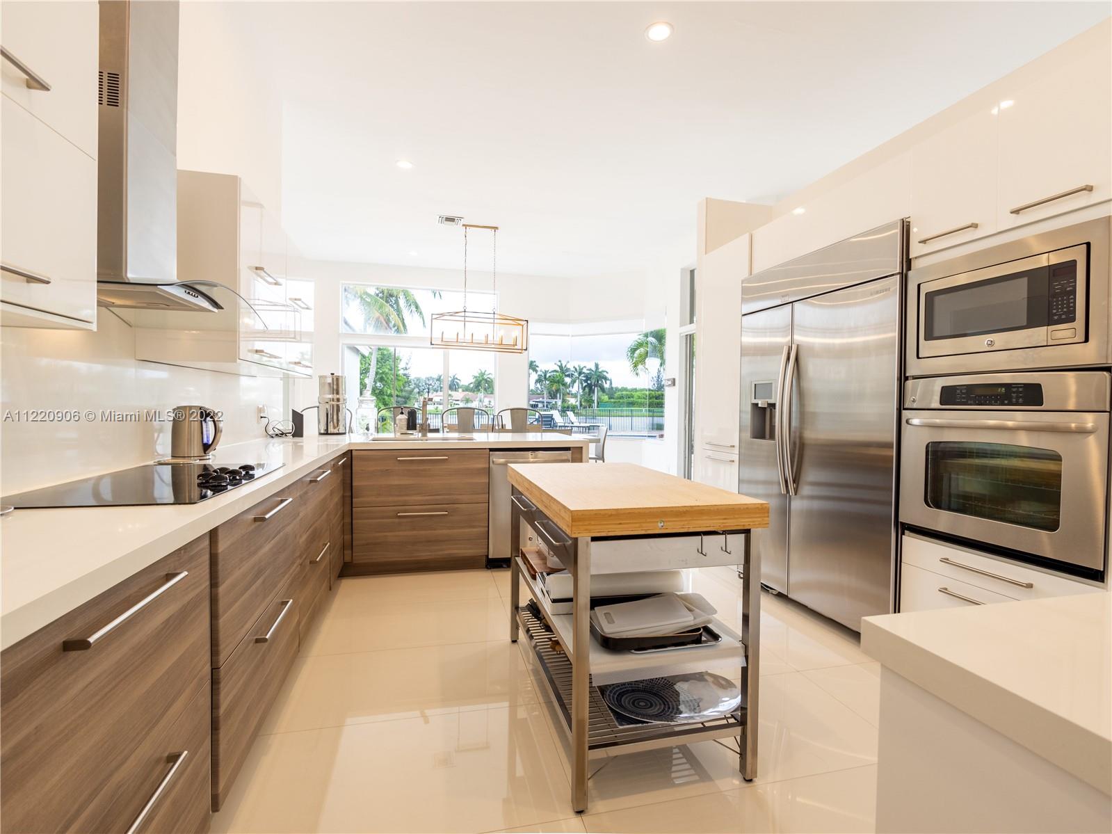 Large kitchen with quartz counters.