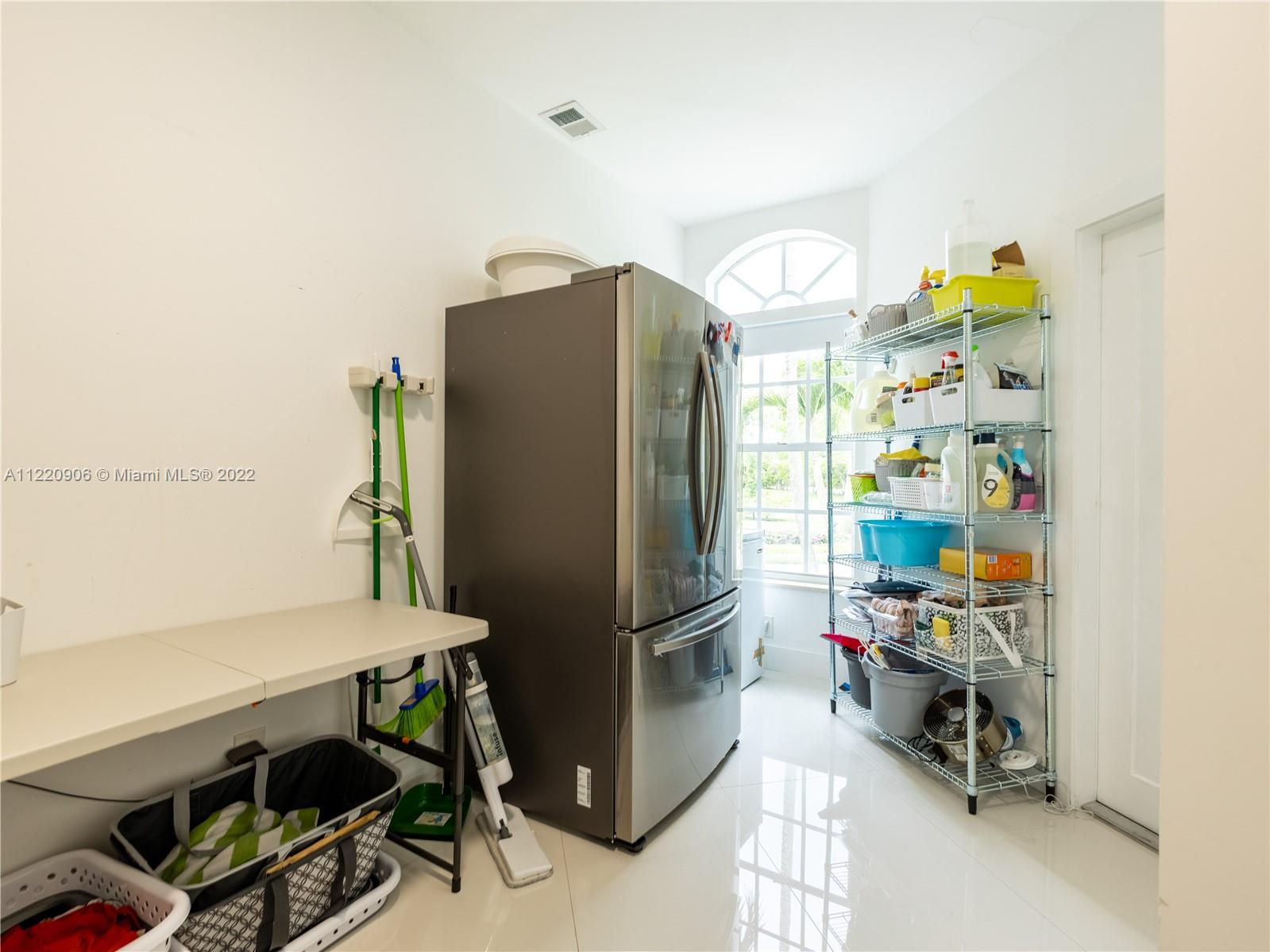 Laundry room with additional fridge