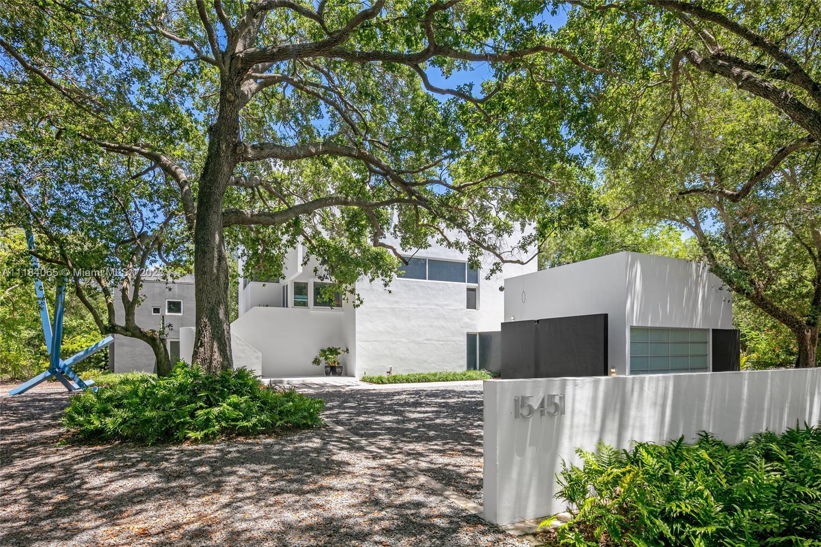 Find your peace at this award-winning, modern architectural masterpiece tucked away in a lush, private landscape. Located in a peaceful, undiscovered pocket, this 7 Bed / 6.5 Bath home boasts 5,451 SF interior and 30,000 SF of land backed onto the Deering Estate Preserve. Originally commissioned by a collector, the Whitton House is designed to showcase fine art. So much so, that it has hosted guests the likes of Warhol, Calder and Lichtenstein. The main house is highlighted by its high ceilings, large windows, library, media & office. The guest house's separate kitchen and private entrances make it perfect for in-laws or a dedicated home office. Paired with its privacy, the home offers unparalleled proximity to the area's top schools. Enjoy this blend of privacy, art and design today.