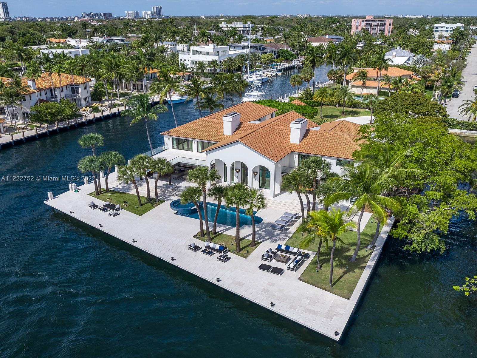 This Las Olas Isles estate has the rare distinction of occupying its own private peninsula, with spectacular views
and approx. 700+ ft. of dockage on three sides, including a protected 285-ft. boat slip able to accommodate a
mega-yacht. The almost 11,000 Sqft. residence offers superlative amenities such as a formal living room with high ceilings, copious balconies and protected loggias for gracious outdoor entertaining, an elegant waterfront pool with spa, a lavish master suite with a private terrace from where one can enjoy endless waterway views, a Crestron smart home system, and a stately motor court which provides access to the car garage. The fireplace and book-matched marble floors in the living room complement the elegant bar, perfect for a grand reception or an intimate nightcap.