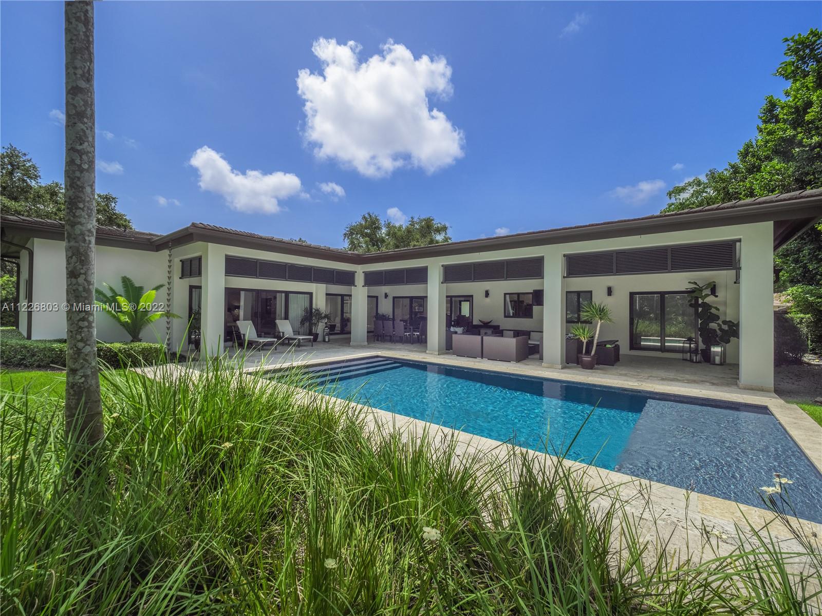 Stunning, move-in ready 5 bed, 3.5 bath home in prime South Miami with perfect split floor plan, incl. 2-car garage & +1,200sf of covered outdoor terrace space and summer kitchen. Hurricane impact doors & windows, 22 kW Generac generator (300gal), pristine porcelain & wood floors, quartz countertops, glass-encased custom wine cellar. Master suite has entertaining room with access to patio, pool and summer kitchen. Massive his & hers walk-in closets and master bath featuring floating vanities. The expansive backyard features 40ft Carpentaria palms, zoysia grass and a variety of native plants & trees. Imported coralina tile & salt water pool.  Mosquito mister system for entire yard & terrace. Substantial addition/remodel was completed in 2013. LIV SF  2,301 - ADJ SF 3,304 – ACTUAL SF 4,087