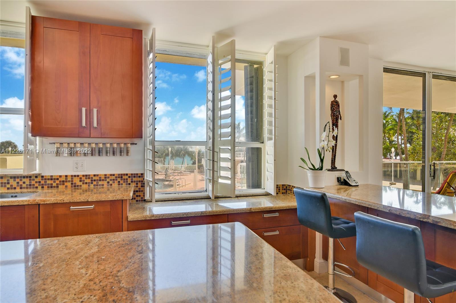 open kitchen looking the Ocean and pool with new hurricane windows