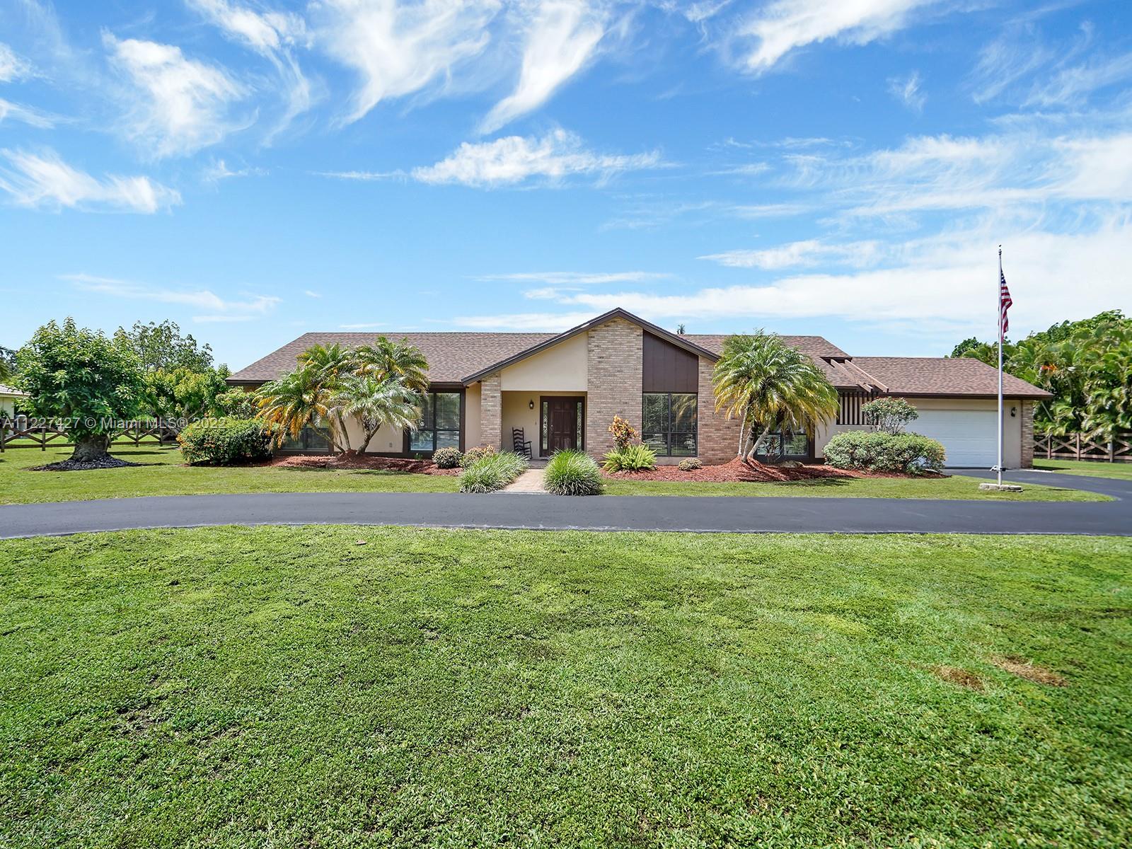 THIS IS A ONE OF A KIND CUSTOM BUILT BY OWNER!  This 4 bedroom, 2.5 bathroom home sits on 1.26 acres fully fenced and with fruit trees (mango and avocado).  Upon entering the home you have a large formal living room and dining room.  The skylights in the kitchen make it bright and airy.  There are custom cabinets and a eat in breakfast nook and a passthru window to the lanai.  Off the kitchen is a family room.  French doors from the kitchen and family room open up to a large lanai.   A new roof was completed in 2019.  This one will not last!