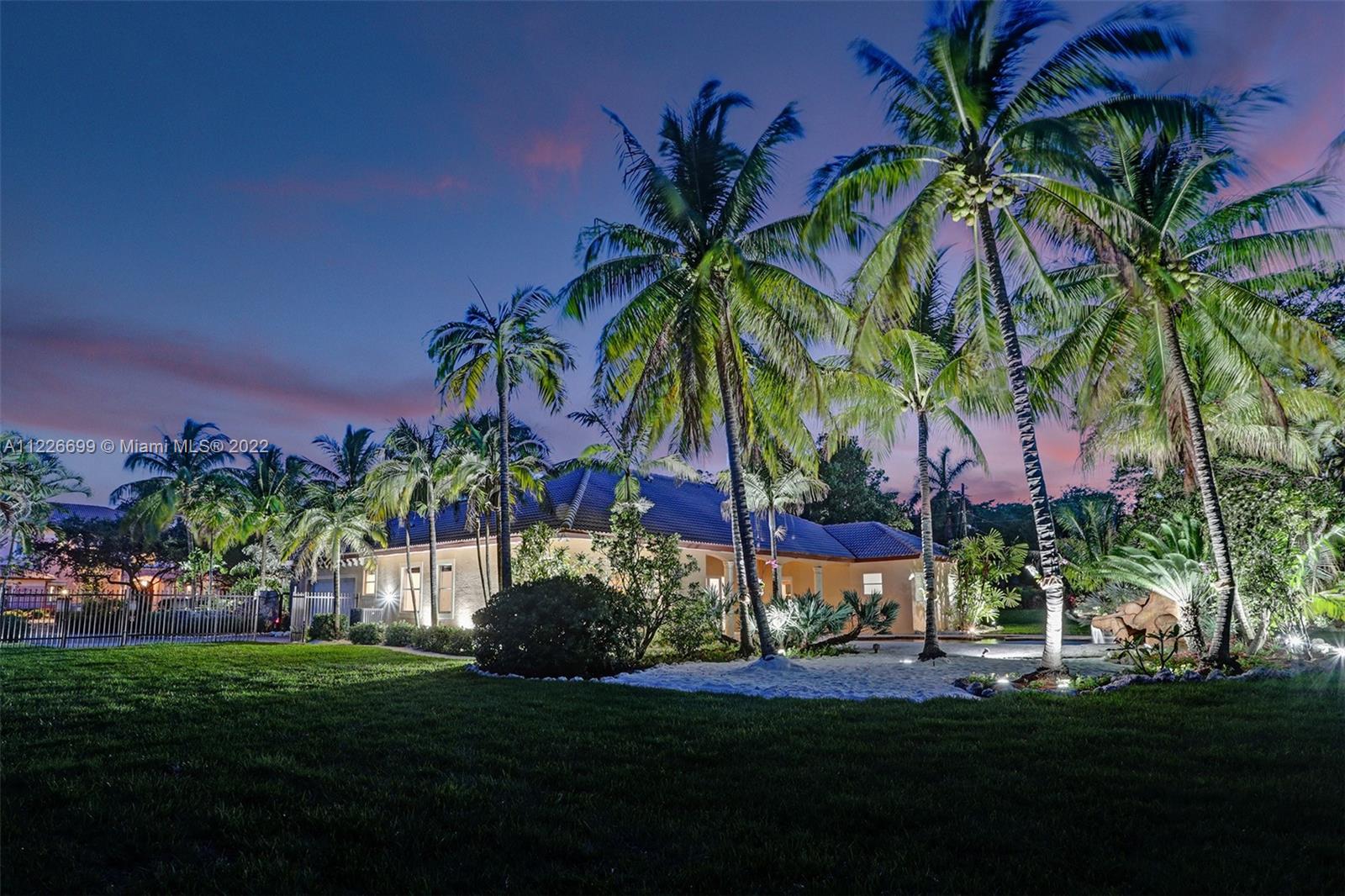 A Tropical Paradise Awaits. Nestled on a corner lot in one of the most sought-after areas in South Miami, this 5Bd/4Ba is one of only 9 exclusive homes that make up Ambience Estates. From the rare coral rock wall that encompasses the front perimeter to the custom & fully automated, saltwater lagoon pool & waterfall in the back, this private oasis meshes opulence with tranquility. Step inside to elegant stone flooring throughout, soaring ceilings, an oversized master suite with his/hers walk-in closets & vanities, & an open kitchen looking out on the grand family room. Entertain outside on the coral rock pool & spa deck, amidst the lush landscaping surrounded by gorgeous palms swaying over your own personal beach. Live luxuriously in an ultra-quiet neighborhood in the perfect location.