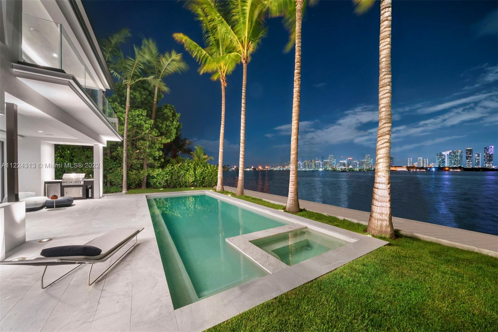 The best skyline view Miami has to offer. Live on the wide-open water and enjoy views of the downtown Miami skyline & the most dramatic sunsets from this contemporary waterfront residence. Enter through a beautiful courtyard to an open layout with breathtaking views from every room. No detail was spared in luxurious finishes throughout this spacious 2 story, 7 bedroom, 7 full bathroom and 1 half bathroom estate. The outdoors are an entertainer’s oasis complete with a private dock, summer kitchen and lounge/dining areas to bask in the views and Miami sun. Complete with a 2 car garage, guest house with its own entrance, a gourmet kitchen overlooking the water, principal suite with a massive walk-in closet, spa-like master bathroom & an expansive balcony offering panoramic views.