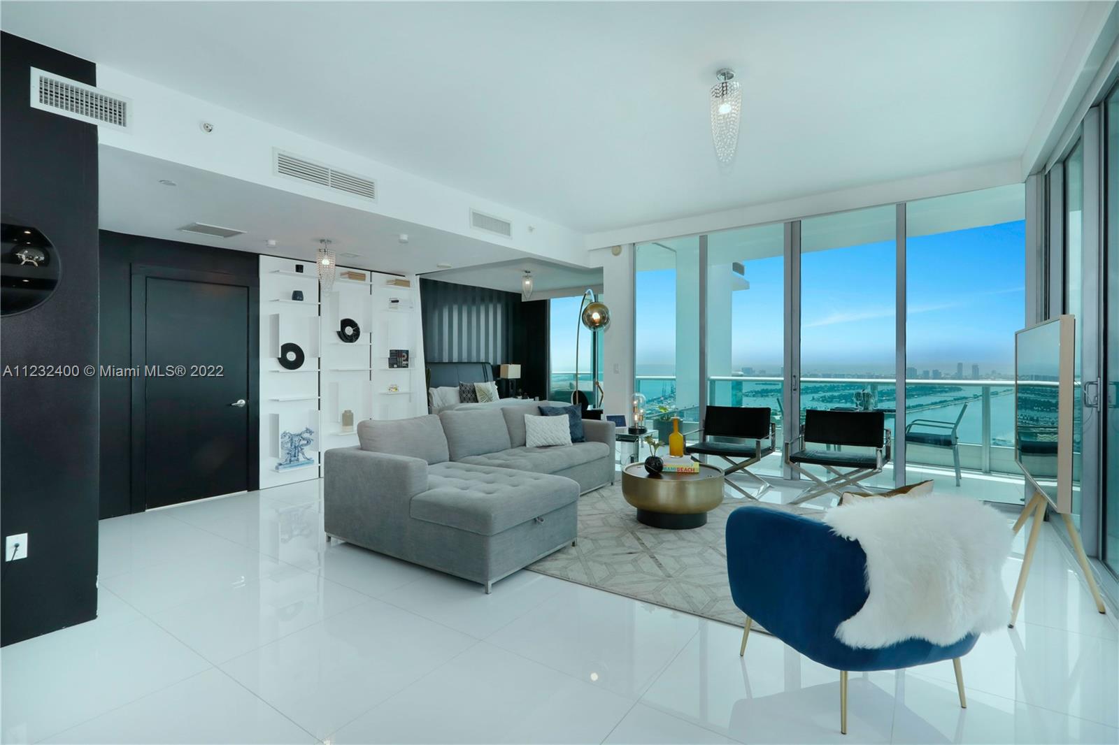 IMPECCABLY DESIGNED HIGH FLOOR FLOW-THRU RESIDENCE WITH STUNNING SUNSETS & PANORAMIC OCEAN, BAY & DOWNTOWN VIEWS! Fully Furnished & Available for Immediate Short Term Rental for 1-6 Months. Private Elevator Entry into Open Floorplan w/ 1,796 SF Living Space + 802 SF of Three Wraparound Terraces w/ 2 Beds + Den + 3.5 Baths. Breathtaking Views from Living Area w/ Custom Built-in White Bookcases. Italian Chef’s Eat-in Kitchen by Aran Cucina w/ SS SubZero & Miele Apps w/ Mirrored Cabinetry, Huge Island & Mirrored Bar + Dining Area. Master Suite w/ Direct Bay Views & Terrace. Master Bath w/ Mirrored Wall & Double Vanity. Custom Lighting & Automatic Shades. Architecture by Luis Revuelta & Common Areas by Sam Robin w/ 2 Pools, Spa, Gym, Lounge, Kid's Room, Theater, Concierge, Valet & Security.