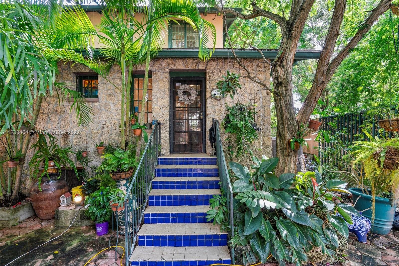 This rare historic home is zoned residential and commercial giving this property unlimited
possibilities. Built in 1921 and hidden behind privacy walls, this home is one of a kind in the heart of Coconut
Grove. This corner lot features a 3 bedroom/2 bathroom main house and 1 bedroom/2 bath guest cottage. Behind the privacy walls there is parking for 8! House features beautiful oolitic limestone exterior walls and the fireplace has an oolitic limestone mantle, beautiful original wood doors and solid hardwood floors upstairs, tiles downstairs, crown molding throughout and a galley kitchen. Main house has 1/1 master bedroom downstairs and 2/1 guest beds upstairs. Located on the back side of Cocowalk, which is less than a block away. This is a true diamond in the rough.