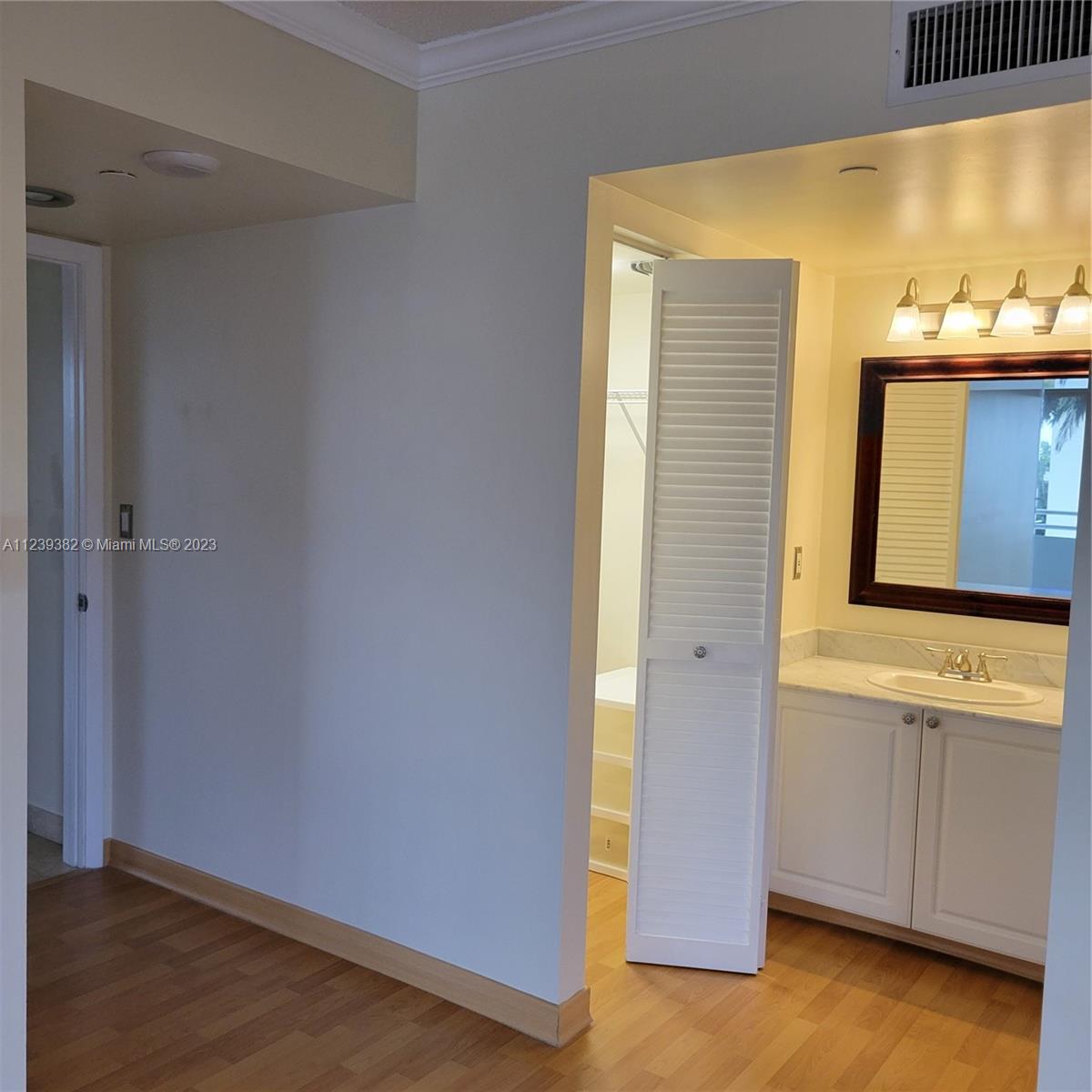 Vanity Dresser next to Bathroom with Shower