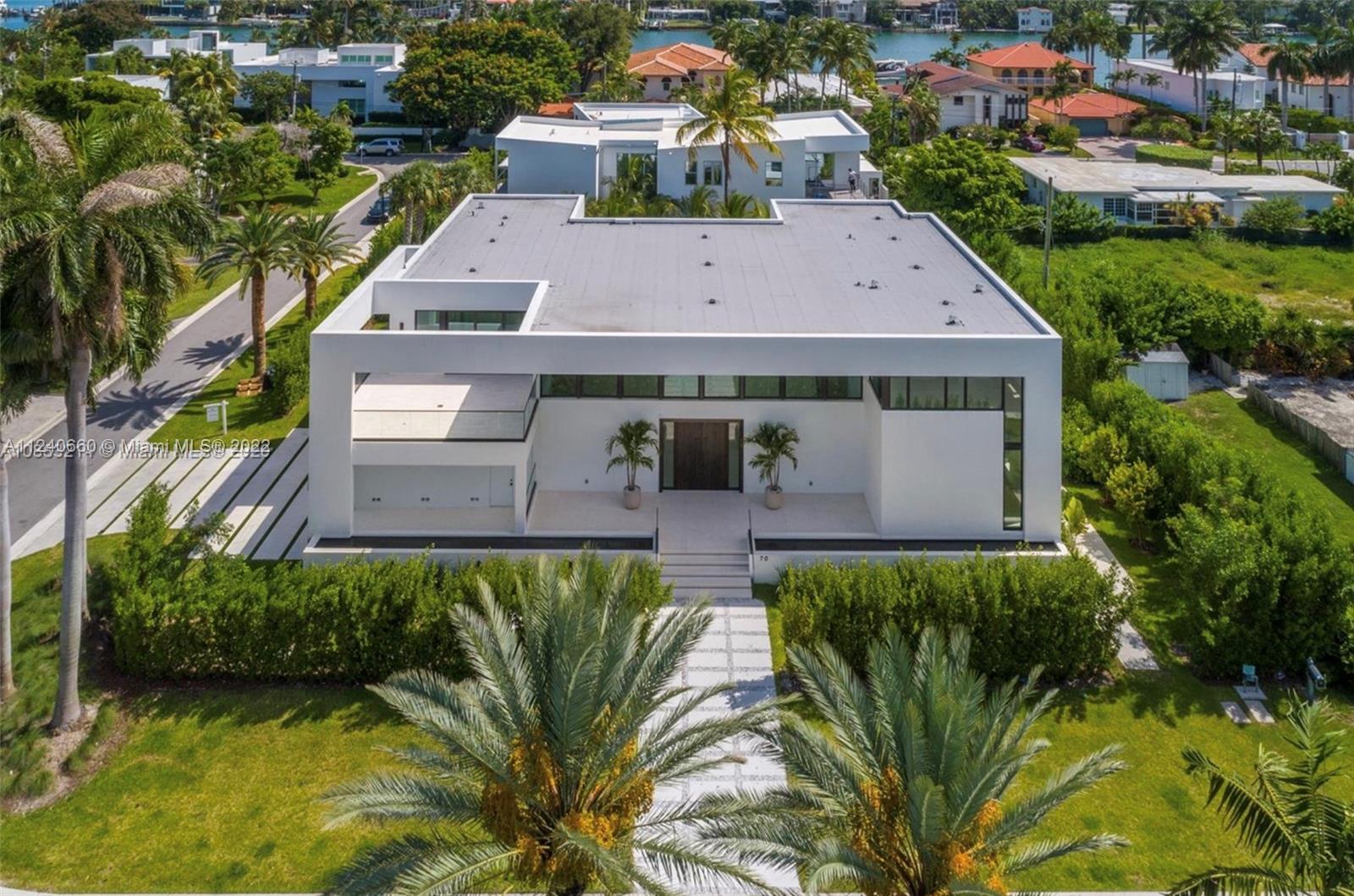 New modern and wonderful house on gated and secured Hibiscus Island. This exquisitely designed (6 bed/6/1 bath) masterpiece was built on a corner lot, with a private entry garden capturing sea breeze, natural light and enhancing views. It features 22 ft high ceilings, white oak hardwood floors and a stunning glass enclosed outdoor balcony. The kitchen is an epicurean delight with a large cooking island, Miele and Wolf appliances. the dining Room opens to the outdoor terrace with a kitchen and bar - perfect for seamless indoor/outdoor entertaining for family and friends. The master bedroom features a sitting area his and hers closets and ample master bathroom. Outside enjoy lounging by the lap pool in the covered terrace.