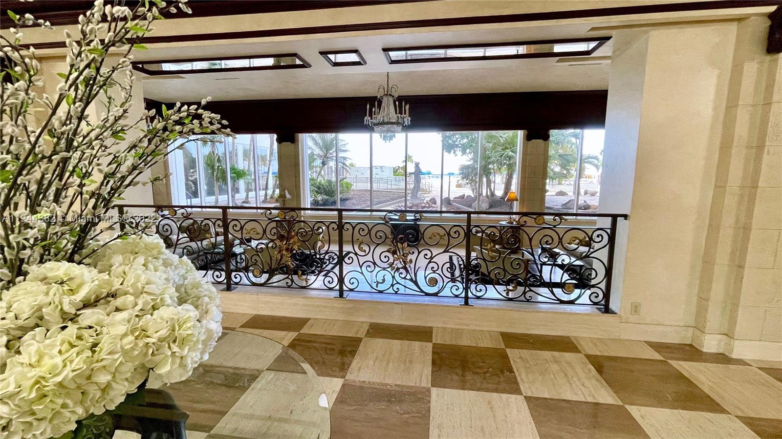 GRAND LOBBY WITH SUNKEN MARBLE SITTING AREA AND PANORAMIC DIRECT OCEAN GARDEN VIEWS