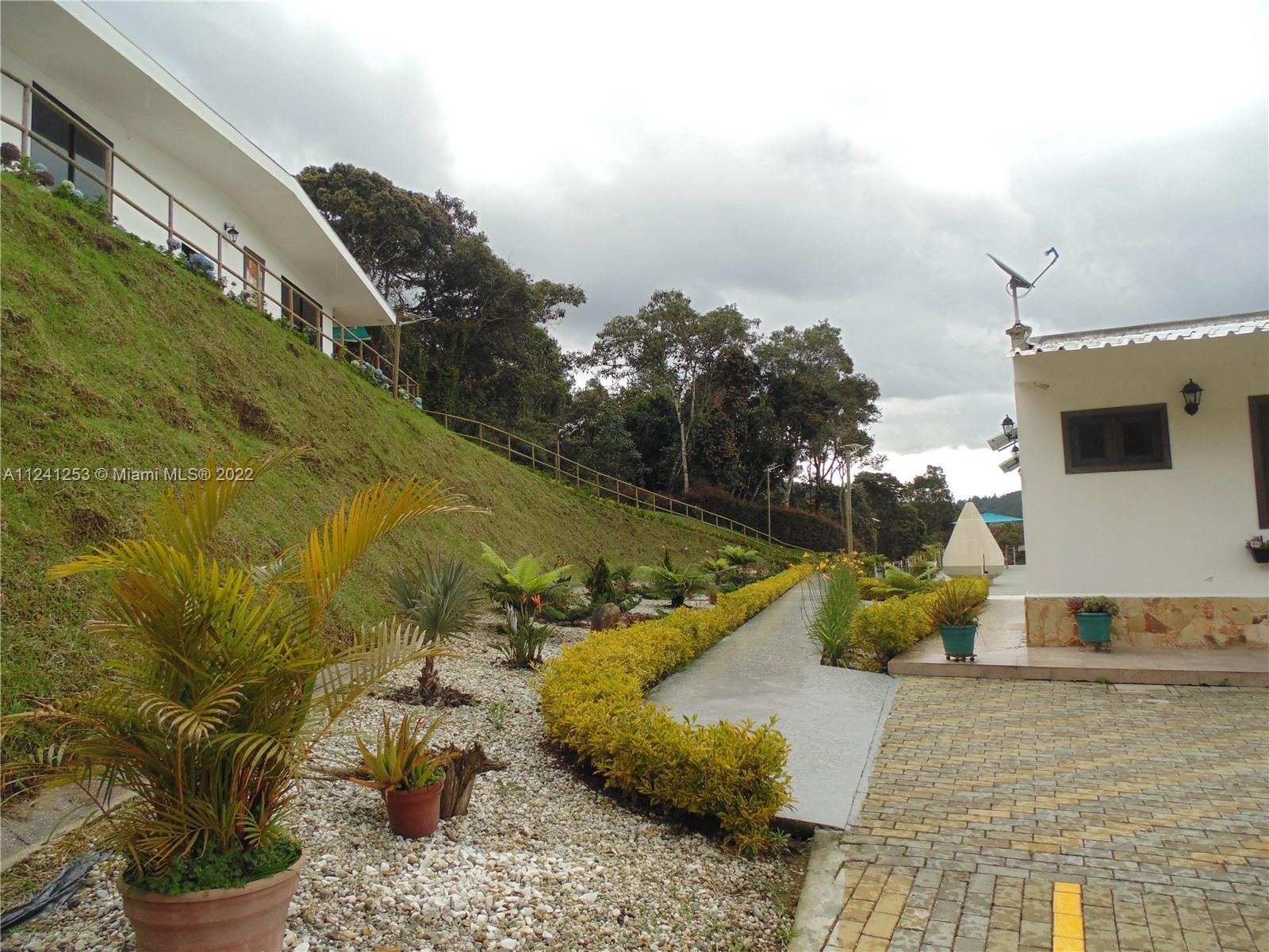 corner parking view the end of main house and guess house in the mountain