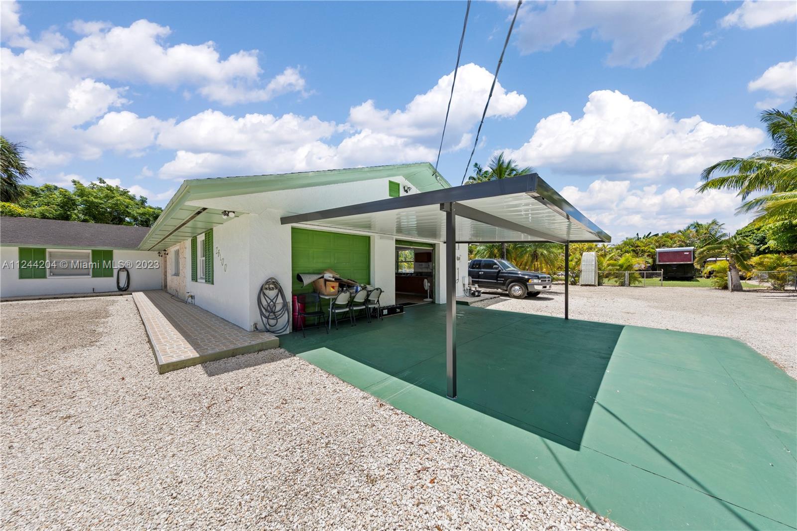 CARPORT AREA FOR ADDITIONAL COVERED PARKING OUTSIDE 2 CAR GARAGE