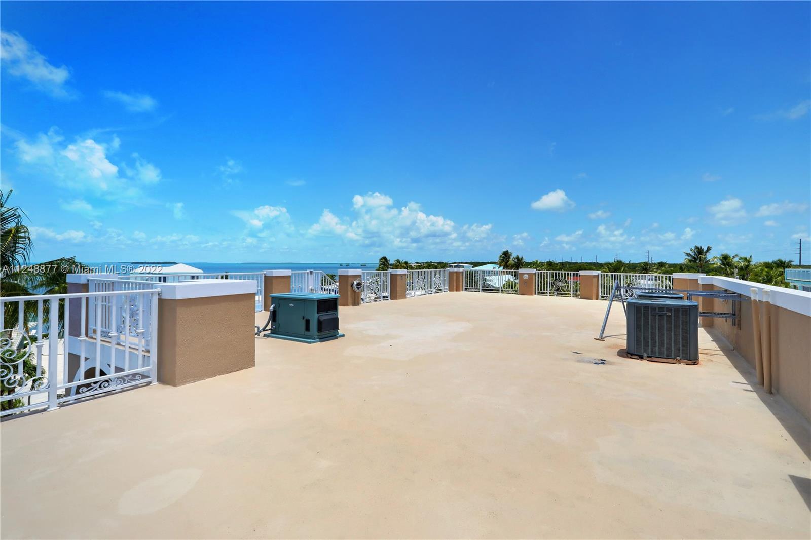 Sundeck view from the Street side. Staircase on the Left. Generator (at Left) and (2) A/C compressors (Right)