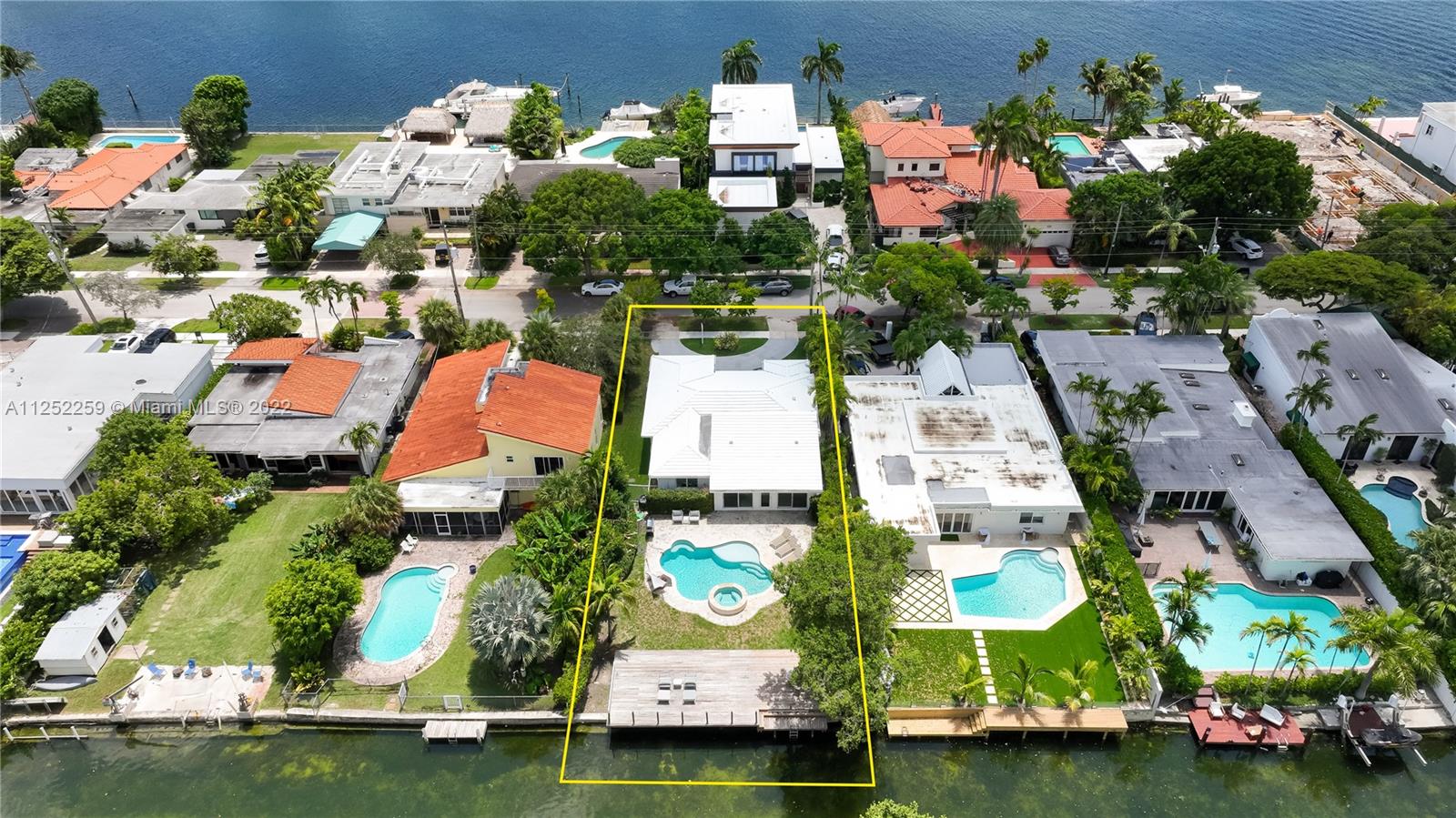Beautiful Miami Beach property is located in the exclusive gated community of Biscayne Point. The home sits on 60’ of prime waterfront great for enjoying the waterways via paddle boards, kayaks, jet skis or small boat. Ocean access with one fixed bridge. The oversized 150’ deep lot allows for a great backyard entertaining with a large heated pool, built-in hot tub and lush tropical landscaping. A new dock and decking was installed in 2017.  High vaulted ceilings and newer hurricane impact windows allow natural to flow through the house. The open-concept living area and four bedrooms creates a highly desirable floor plan. There are natural oak and porcelain floors throughout. The kitchen has granite countertops and modern stainless steel appliances.