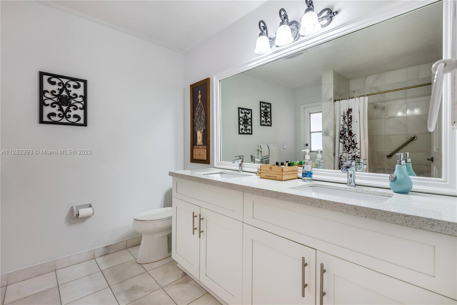 Independent White Marble Shower with pebble floor and beautiful finishes