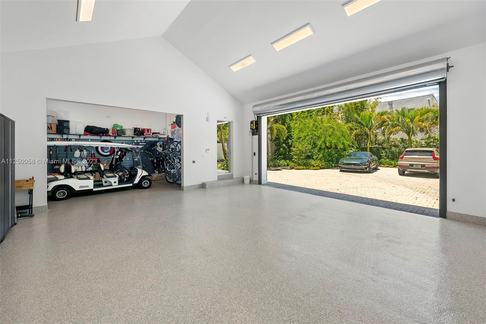 HIGH CEILING GARAGE WITH SEPARATE GOLF CART PARKING AND ELECTRIC CAR CHARGES