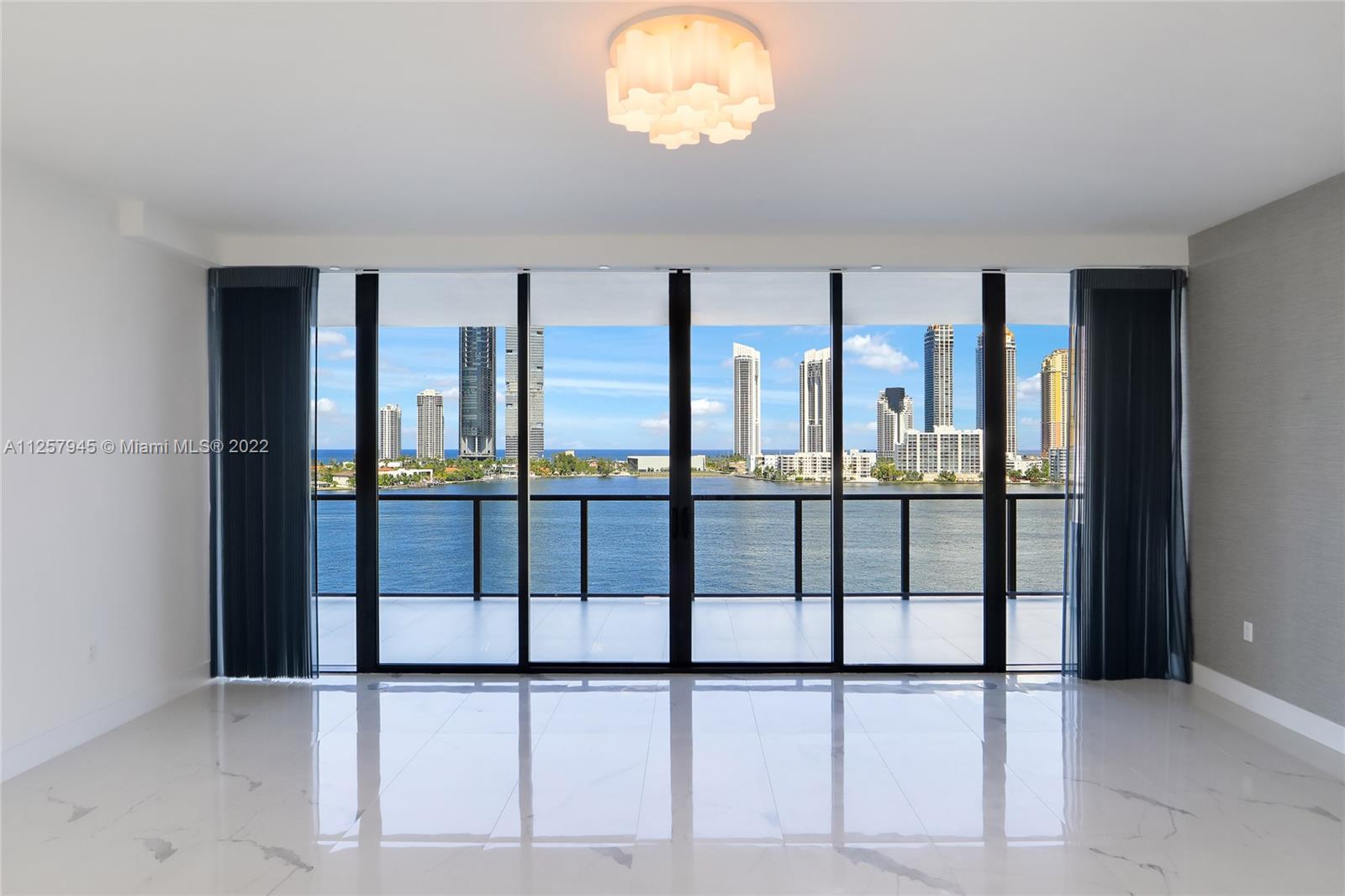 LIVING ROOM WITH DIRECT OCEAN, INTRACOASTAL AND CITY VIEWS