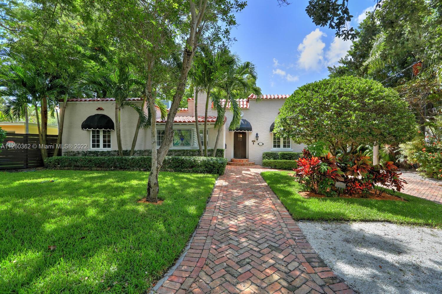 Lovely home on a quiet tree-lined street in prestigious North Coconut Grove. Walk or bike to bayfront parks & marinas and to the Grove village center’s galleries, boutiques and sidewalk cafes.  Floorplan includes formal living w/fireplace & family room w/stunning wood-beamed ceiling & glass wall overlooking the garden. Wood & stone flooring + impact windows throughout. Sleek, european-style kitchen features wood cabinetry & top-of-the-line appliances. Master bedroom has an oversized walk-in closet with built-in cabinetry. 4BR/2.5BA includes connected “guest suite” w/ separate entrance. Private & tranquil outdoor living spaces feature wood deck and lush tropical landscaping. Room to add a pool. Just minutes to downtown, MIA, Key Biscayne & the Beaches