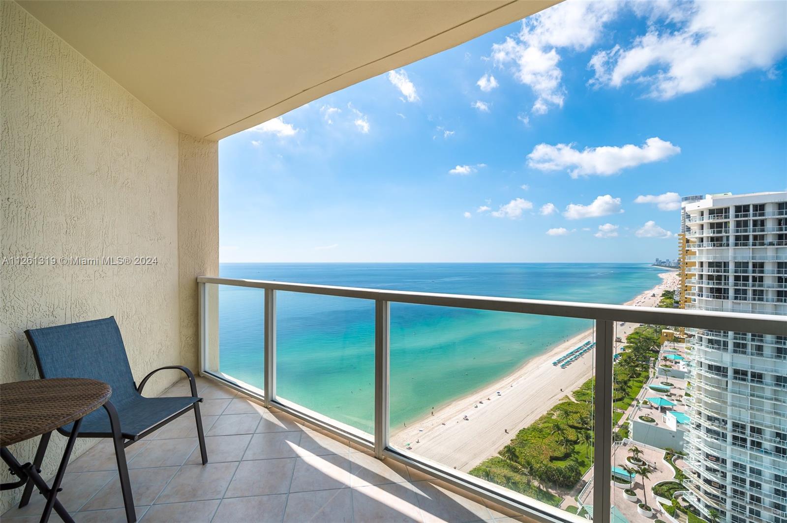 Second bedroom with private balcony, ocean views, on-suite bathroom, and walk in closet