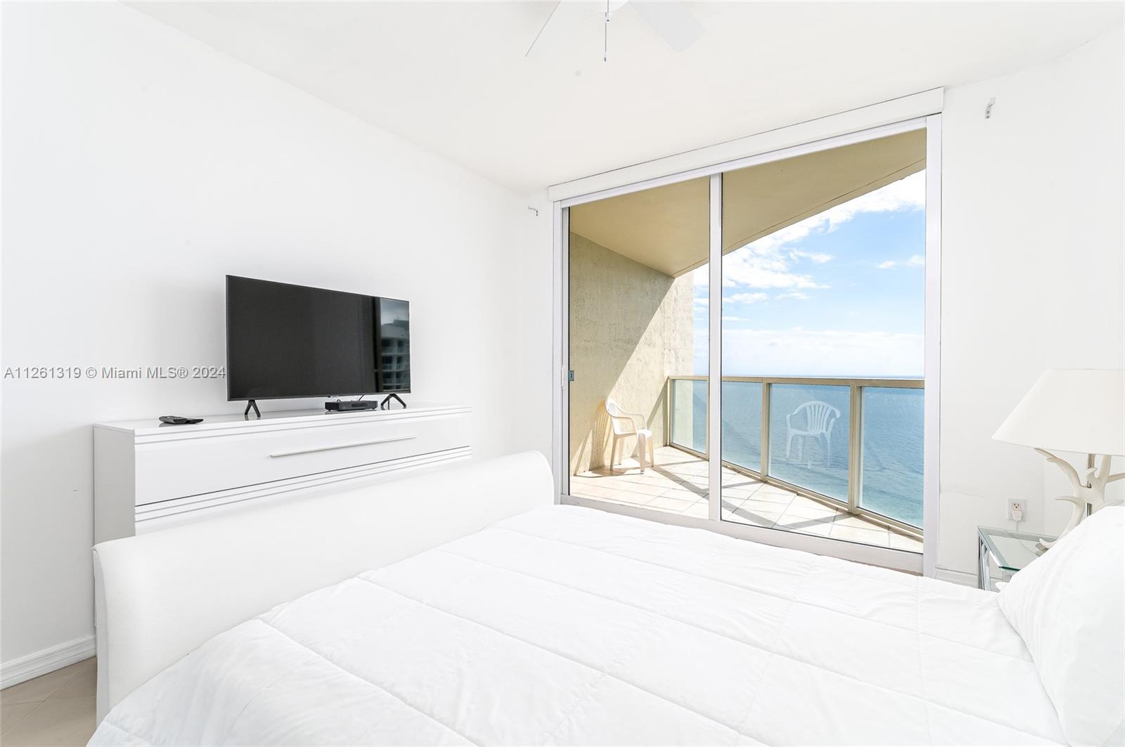 Second bedroom with private balcony, ocean views, on-suite bathroom, and walk in closet