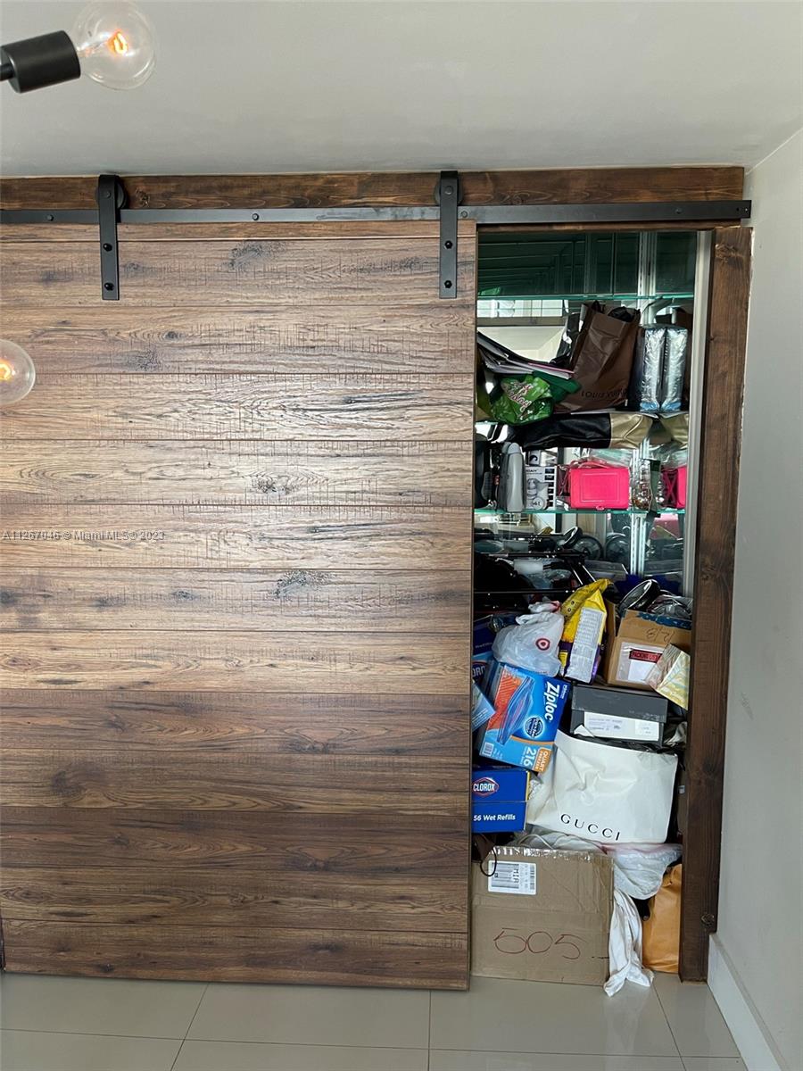 Barn door in Dining area with ample storage room behind. Can also de bar area