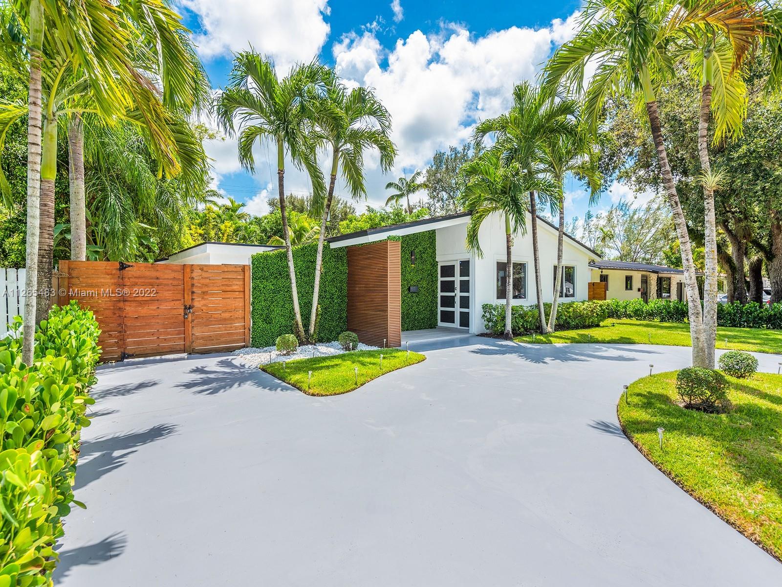 Located in a prime location of South Miami, this gorgeously renovated home features 4 beds, 4 baths and an airy, light filled grand entertaining area with modern kitchen complete with custom cabinetry, quartz counters and stainless appliances. The master suite and ensuite bedrooms boast beautiful finishes and walk-in closets with custom cabinetry. Outside, the covered patio offers a large seating area, custom decor planting wall and ceilings with an adjacent sun soaked patio. The backyard has a large recreation lawn perfect for a future pool and/or playground. A dedicated laundry room w/ exterior access, wide format porcelain flooring throughout, styled LED lighting and architecturally thoughtful design touches highlight this exquisite property. Walk/Bike to nearby downtown South Miami.