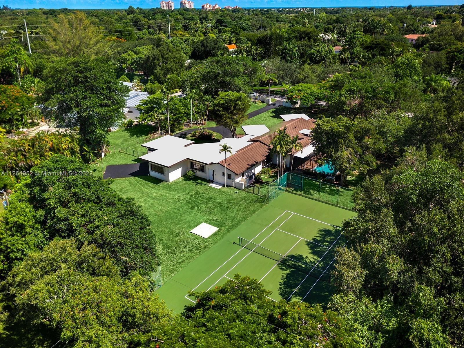 Incredible opportunity to build your 18,000+ Sq.Ft dream home on this 1.52 Acre lot with a tennis court. Or you could renovate this existing home offering 5 bedrooms and 3/1 bathrooms plus guest/in-law suite with private access. Enjoy a vast outdoor space with screened pool/patio and a huge front and back yard. Being sold for land value.