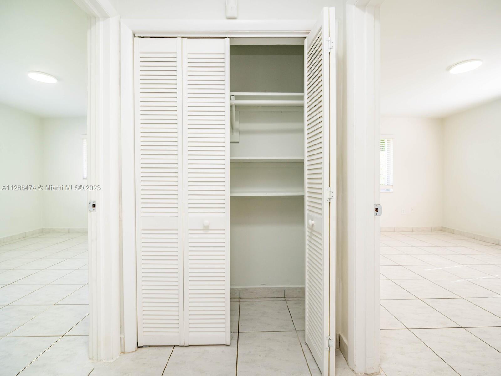 Hall way closet separating main bedroom from corner bedroom