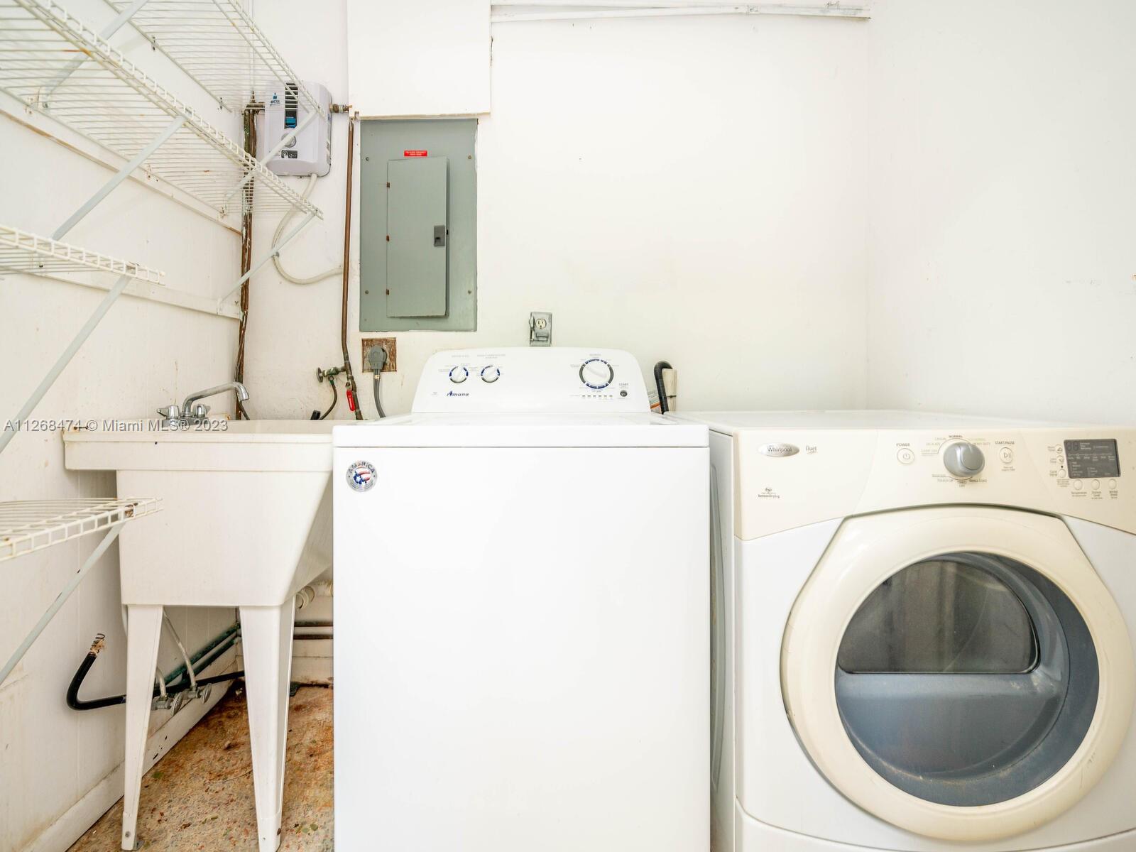 Laundry room with utility sink inside back entry room