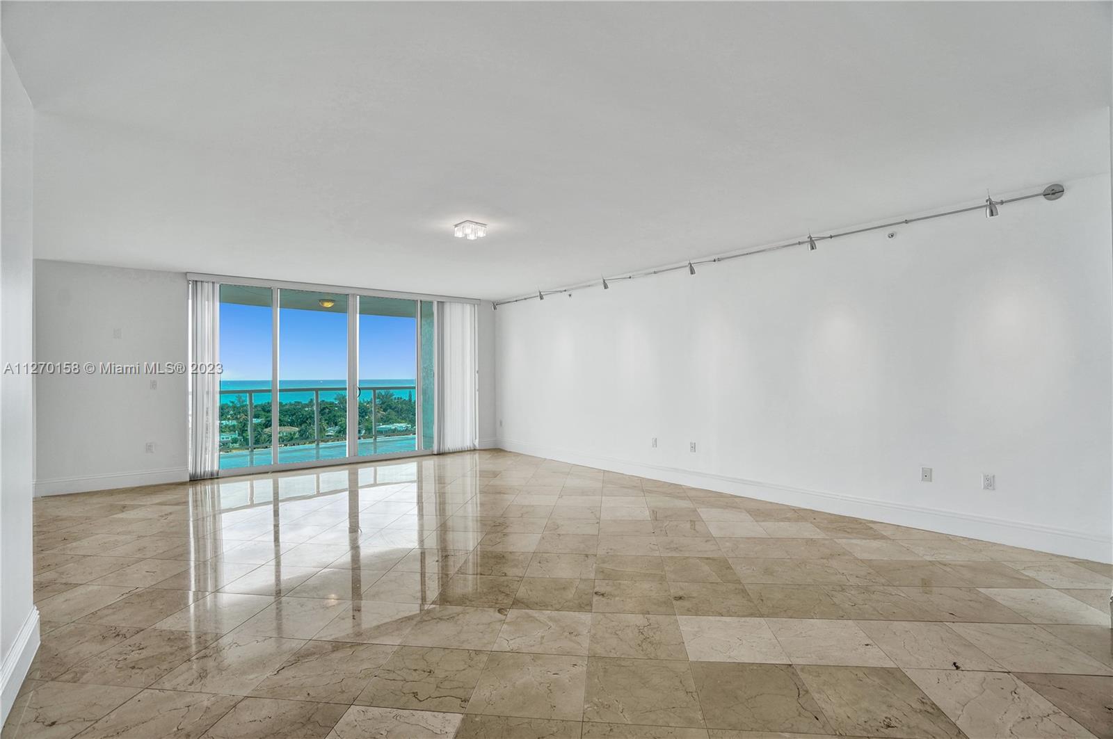 Spacious living room with a direct ocean and Golden beach views.