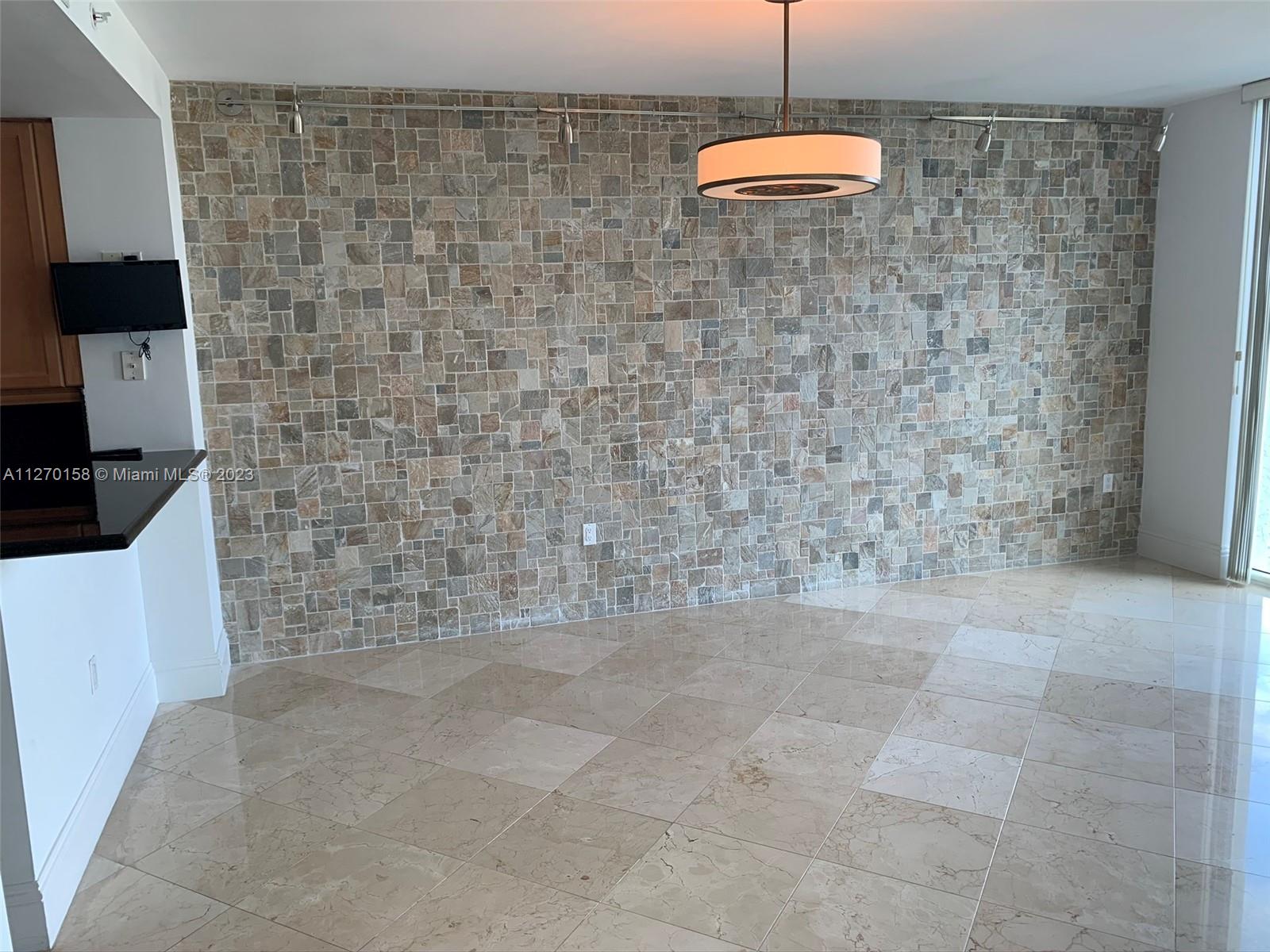 Beautiful texturized stone wall in dining room.