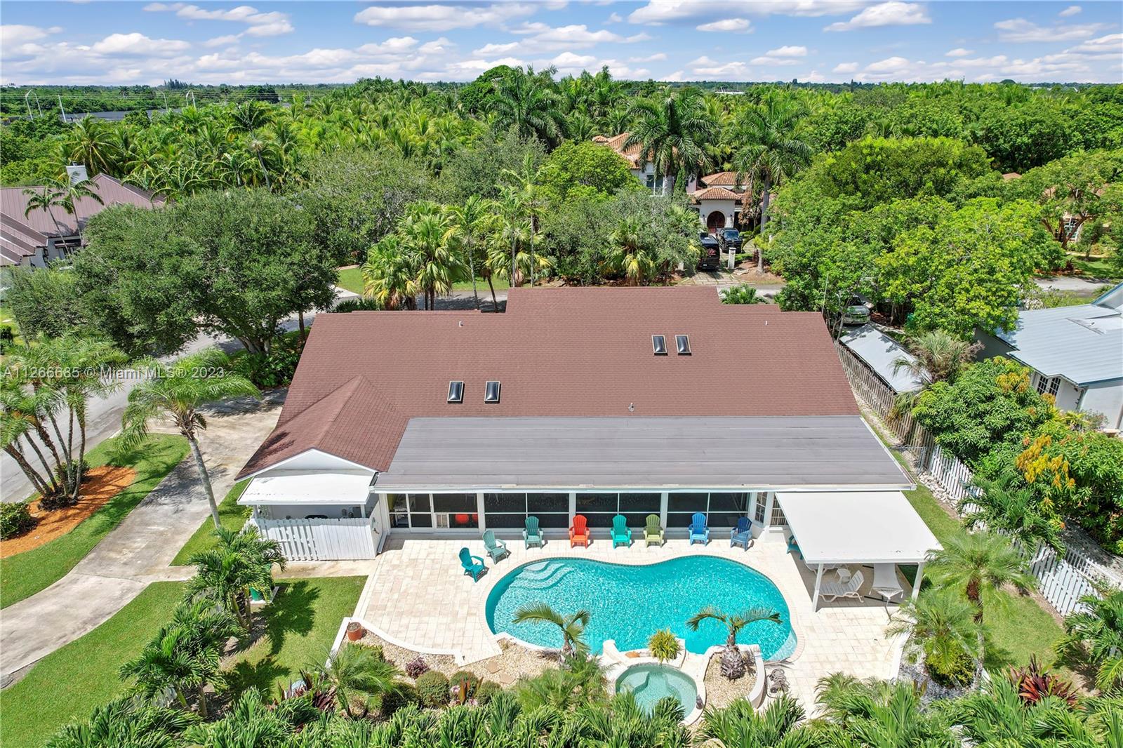 REAR VIEW OF THE PROPERTY...COUNTRY RIDGE ESTATES 1/2 AN ACRE POOL HOME W/ 4 BEDROOMS, 3 BATHS, 2 CAR GARAGE, HUGE PARTY PATIO IN A PRIVATE REDLAND COMMUNITY..