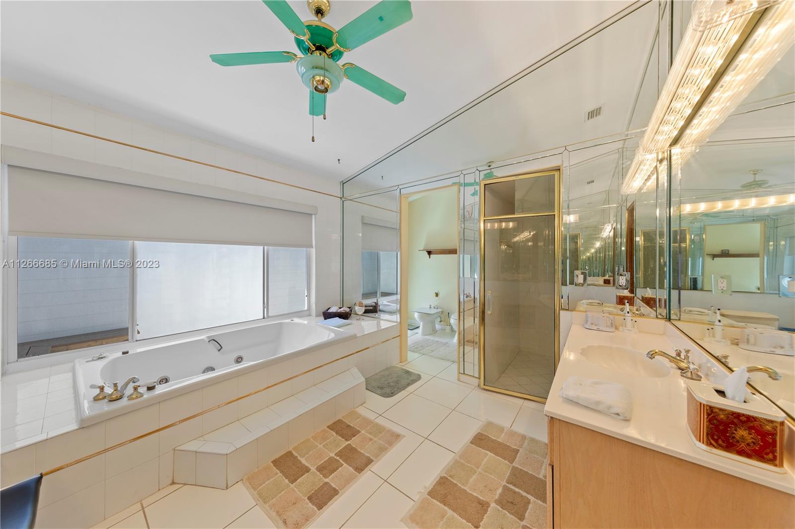 MAIN SUITE BATHROOM W/ DOORS LEADING TO PRIVATE PATIO OFF OF SPA BATH, LARGE SHOWER, & PRIVATE RESTROOM W/ BIDET.