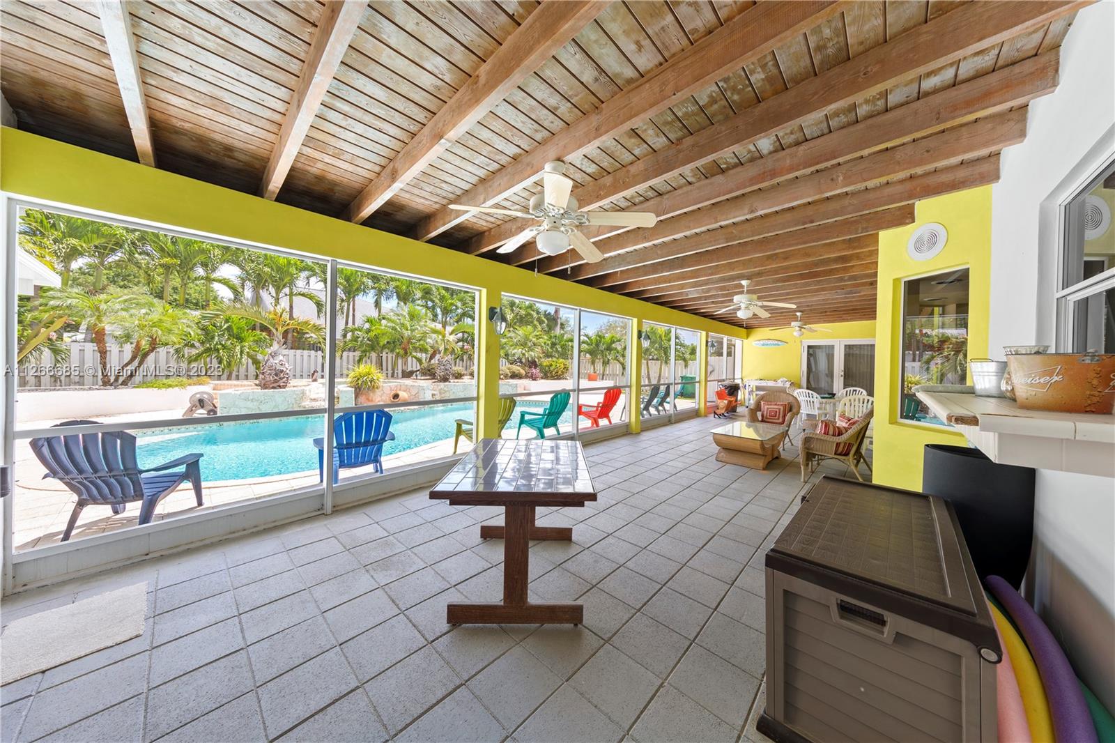 PARTY PATIO COVERED & SCREENED W/ T&G CEILINGS ALMOST THE LENGTH OF THE HOUSE. 6 SETS OF FRENCH DOORS LEADING TO THE PATIO, ALSO WITH HURRICANE SHUTTERS YOU CAN CLOSE IN THE ENTIRE PATIO