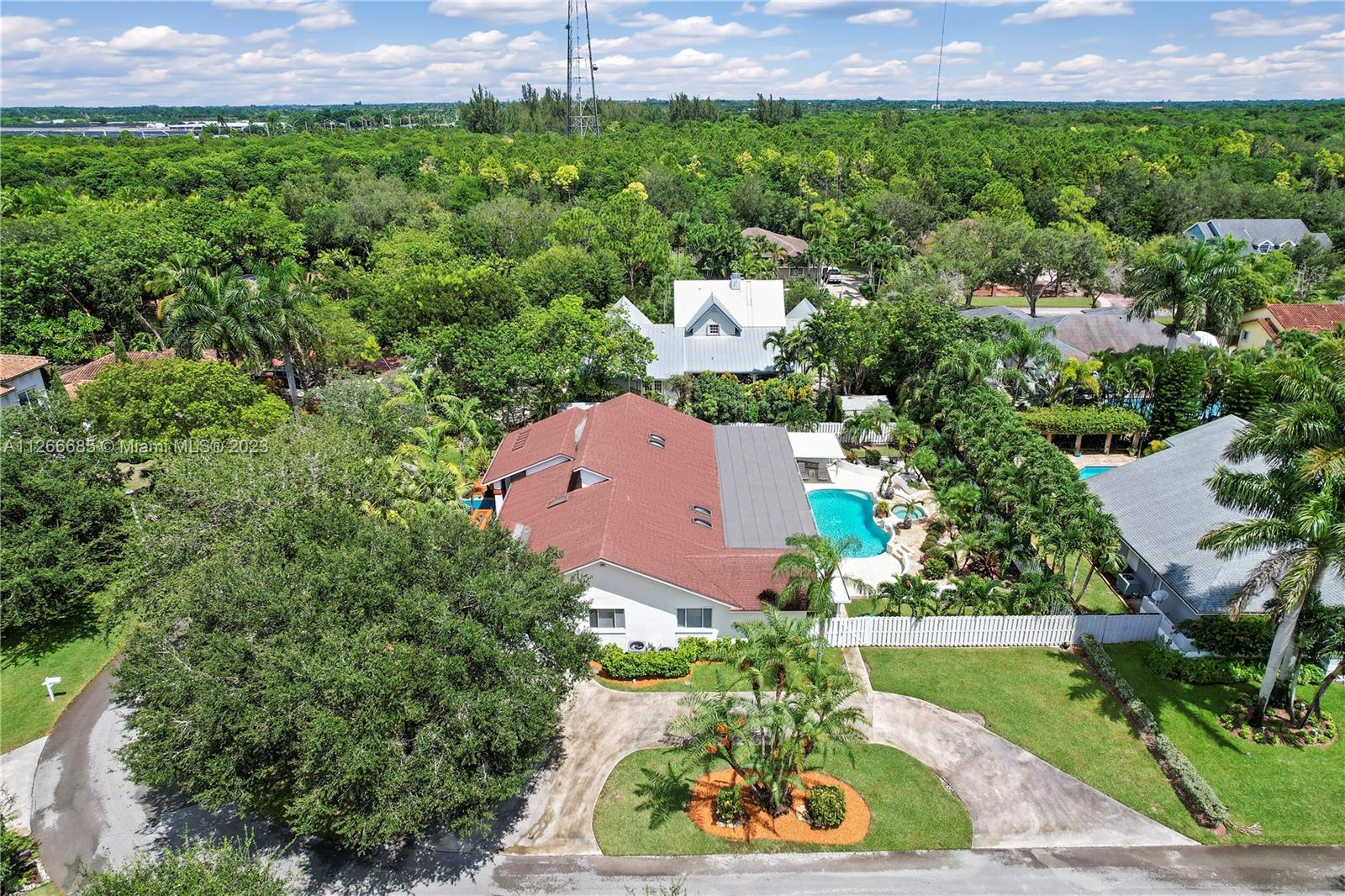 AERIAL OF NEIGNBORHOOD AND THE 2ND CIRCLE DRIVEWAY. THIS SIDE OPENS INTO THE GARAGE.....LOVE THE TREES! REAR FENCED FOR THIS PET FRIENDLY COMMUNITY