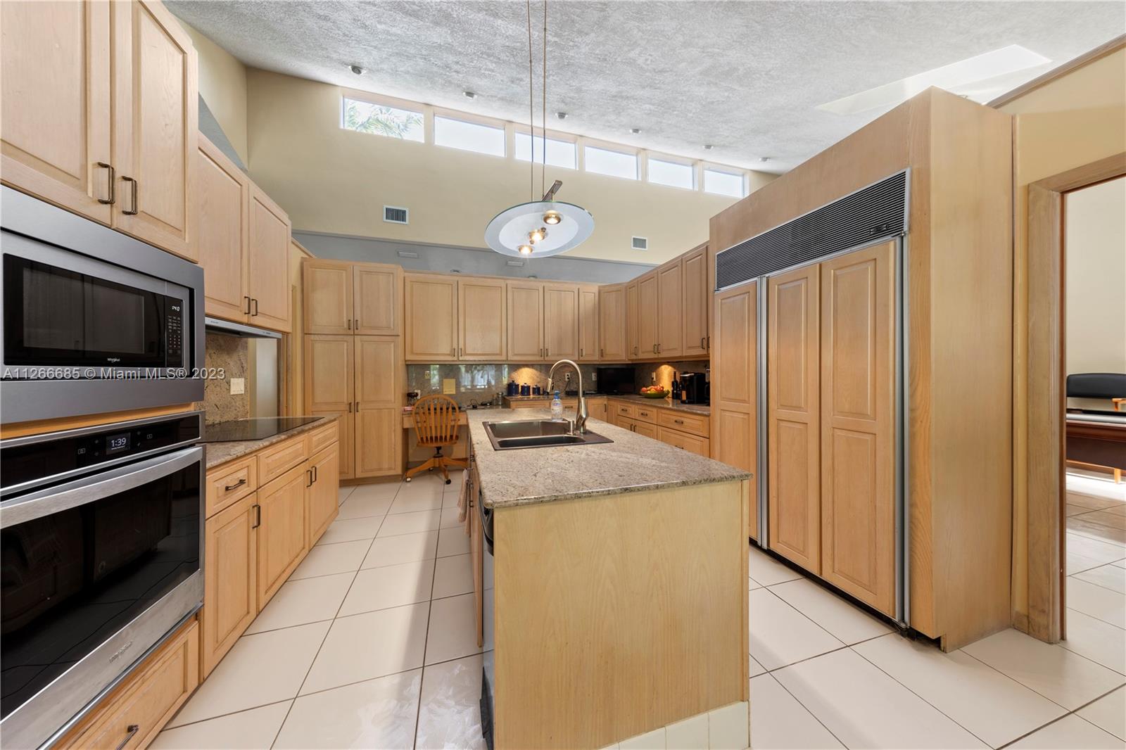 LARGE & FULL OF LIGHT CHEFS KITCHEN W/ CUSTOM CABINETS, CENTER ISLAND & BREAKFAST NOOK