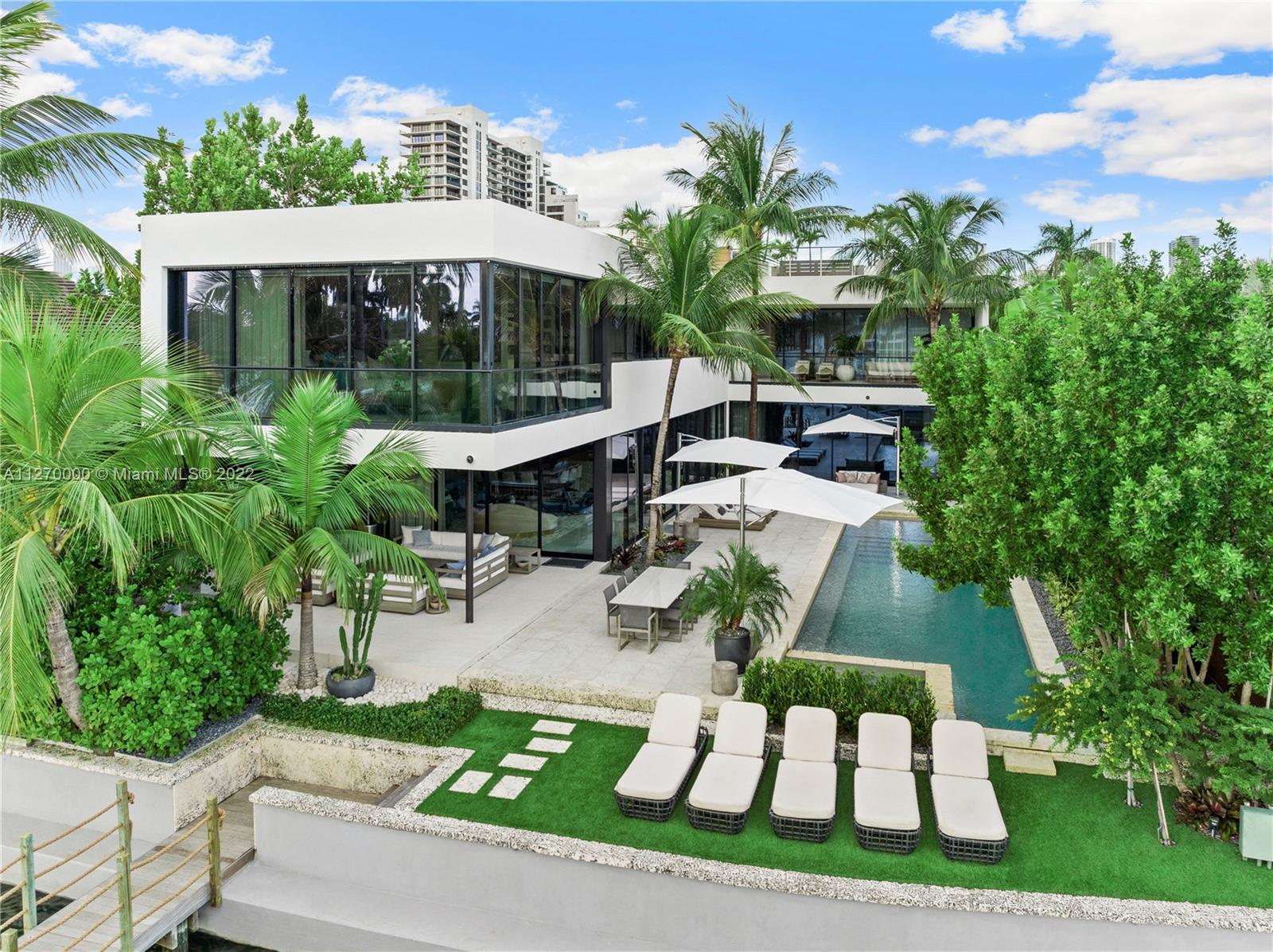 A stunning tropical contemporary home located on the tip of coveted Biscayne Island with unobstructed breathtaking views of Miami & Biscayne Bay. Redesigned in 2020 with an approx. $5M renovation, this residence offers telescopic floor to ceiling pocket sliding glass doors which seamlessly blend the interior space with the lush gardens & pool. Surrounded by a perfectly manicured lawn, exotic imported palm trees & living walls, 1000+ SF of outdoor spaces & an expansive rooftop to take in the beautiful sunsets. Boasting Italian porcelain & wood flooring, custom teak kitchen cabinets, industrial double subzero refrigerators & Bosch & Miele appliances. Located on the Venetian Islands between Miami Beach & Downtown & minutes away from Sunset Harbour, Design District, Wynwood & MIA Airport