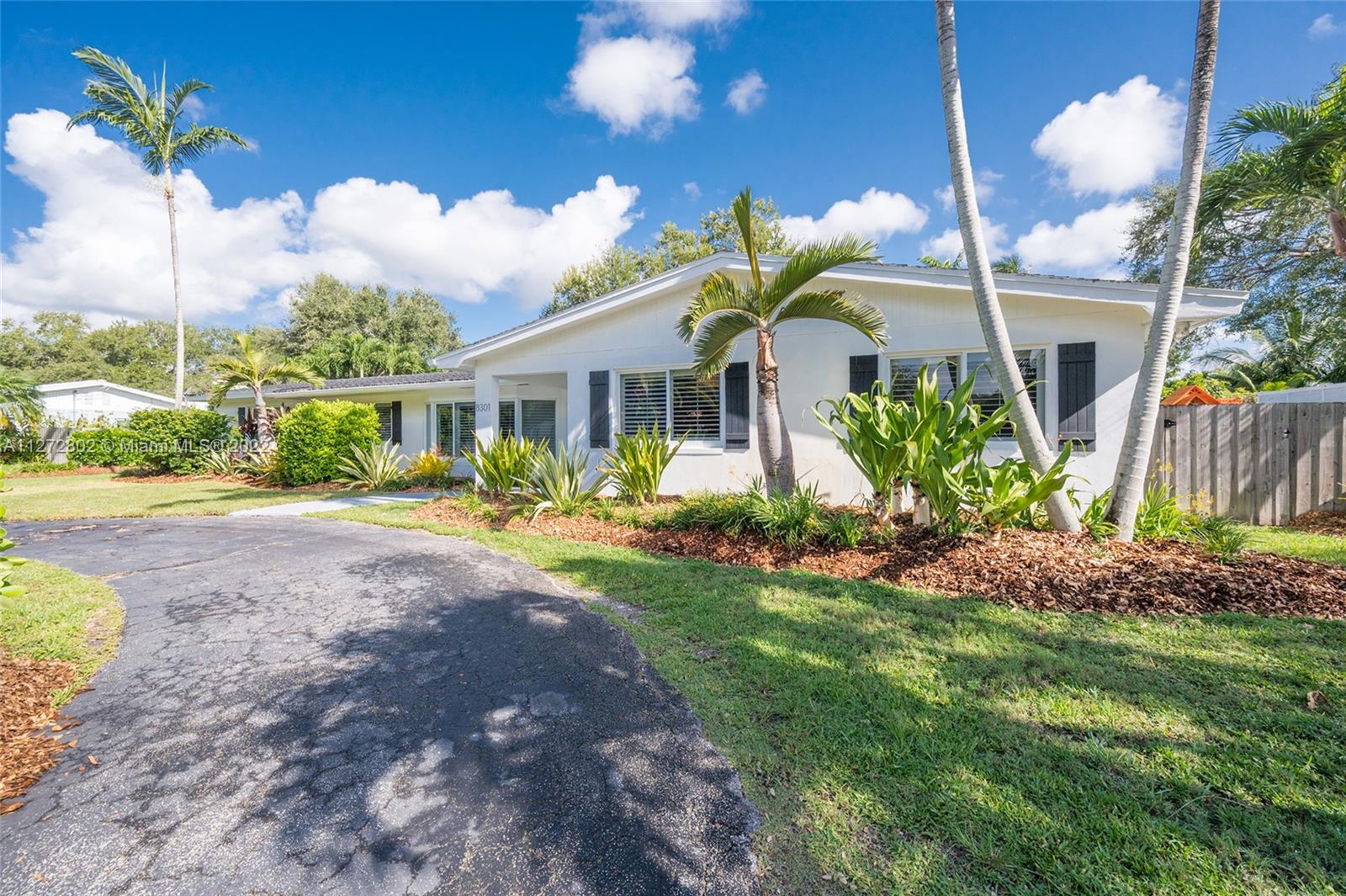 Beautifully updated 4 bedroom and 2 bath home with bonus TV/playroom/den and half bath, full 2 car garage with built in closet with A/C, 3,325 actual area sq. ft. home on a 15,100 sq. ft. lot in the prestigious village of Palmetto Bay near top rated private and public schools.  This recently remodeled home (2018/2019) located on a quiet street has brand new floors throughout, impact windows and doors, brand new wood kitchen cabinets with stainless steel appliances and quartz countertops and updated baths.  Master bedroom has wood floors with custom built closet and in suite bath that opens up to the patio area.  Plumbing was updated in 2016 to PVC (no cast iron).  Oversized fenced backyard with plenty of room to park a boat has working sprinklers, a covered patio and chlorine pool.