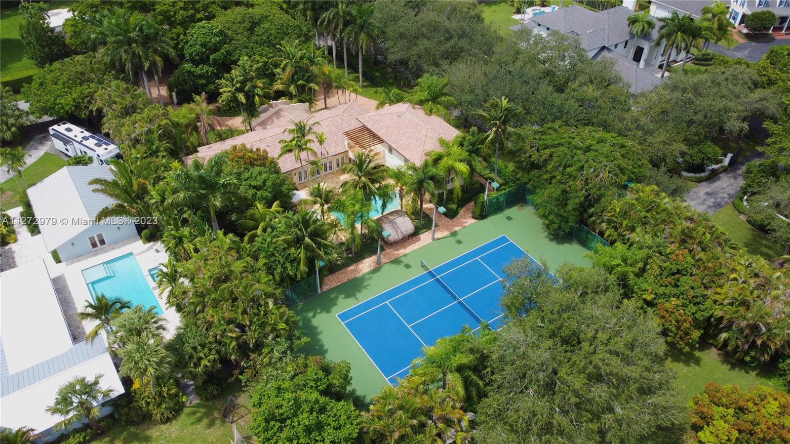 PRIVACY-LUXURY-SECURITY Escape to your Lushly Landscaped Tennis Heaven Two Story Resort Style Villa, Located in Prime North Pinecrest. This split plan (2-3) 5BR/5BA,(4-Suits) fully gated, Corner Lot. An Immaculate Turn-key Estate thoroughly Remodeled in 2020 & Rebuilt 2011 W/ upgrades to the highest standards for hurricane protection, W/MDCPA Listing Effective Age@ 2011, Quality 1 Grade 1. Captivating open view line of sight from social areas & kitchen to all the action on the regulation sized N-S lighted tennis court and sparkling blue salt system pool. Huge open floor plan living room/dining room and amazing white quartz gourmet kitchen, with high ceilings, onyx and granite bathrooms, build-in-closets on every suite, amazing laundry room, state of the art security system and much more!