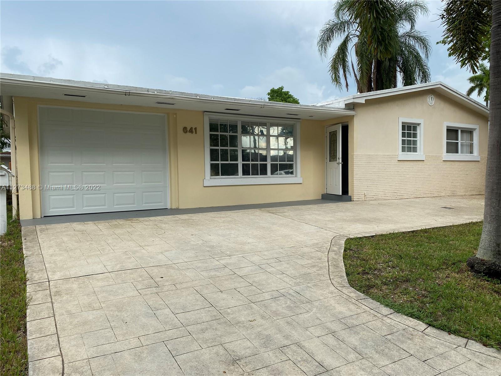 LIVE IN THE HEART OF HALLANDALE BEACH. VERY SPACIOUS SINGLE FAMILY HOME, 3/2, WITH AN OVERSIZED FAMILY ROOM ( COULD BE CONVERTED TO A FOURTH BEDROOM), WOOD LAMINATE FLOORS THROUGHOUT, HUGE LIVING/ WITH A FORMAL DINING ROOM, VERY SPACIUOS KITCHEN ( BRAND NEW REFRIGERATOR, AND RANGE OVEN STOVE. HOUSE HAS A SEPARATE LAUNDRY ROOM. CIRCULAR DRIVEWAY WITH A 1 CAR GARAGE. THIS IS A CORNER HOME, WITH AN OVERSIZED LOT. MASTER BEDROOM HAS FRENCH DOORS THAT LEAD OUT TO A WOODEN DECK TO YARD. NO HOA.
