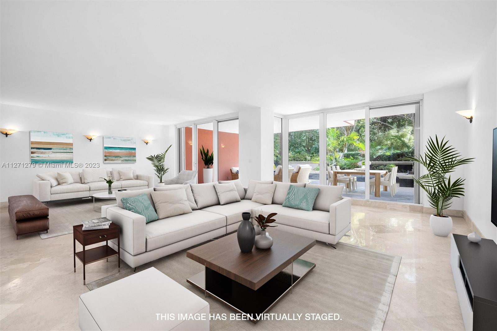 Enjoy the best of both worlds! Live in a two-story condo that feels like a private home with a large spacious floor plan and an oversized garden terrace that is great for entertaining. Soothing greenery gives a feeling of being in your own backyard. Only a handful were built, therefore rarely on the market.  It features 4BR, 5BA, formal dining room, kitchen with breakfast area, family room, living room, den, staff quarters, laundry room, 3 balconies and the best of all 3 parking spaces.  Just steps to the beach, resort style living, private club, restaurants, spa, beauty salon, fitness center, tennis, pools and 24 hour guarded entrances. Special Assessment has been PAID IN FULL.