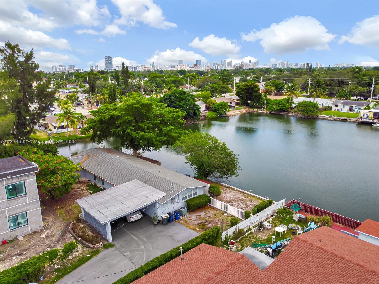 Welcome to this amazing waterfront home! Tastefully & entirely remodeled and situated on an oversized corner lot surrounded by water, with amazing views and over 10,000sqft lot. Open concept and spacious split floor plan. Beautiful porcelain floor throughout, new kitchen with dark wood cabinetry, built in oven and cooktop stove, wine cooler and beautiful granite counter tops. Newer bathrooms with glass shower doors. Large laundry and pantry area. Smart technology features such as NEST A/C system & Digital door lock. Newer roof and electrical panel. Carport for 2 cars, plus plenty of space on long driveway. Conveniently located steps from supermarket, easy access to I95 & less than 3 miles to the beach. 

Perfect investment option for Airbnb/Short Term rental property.