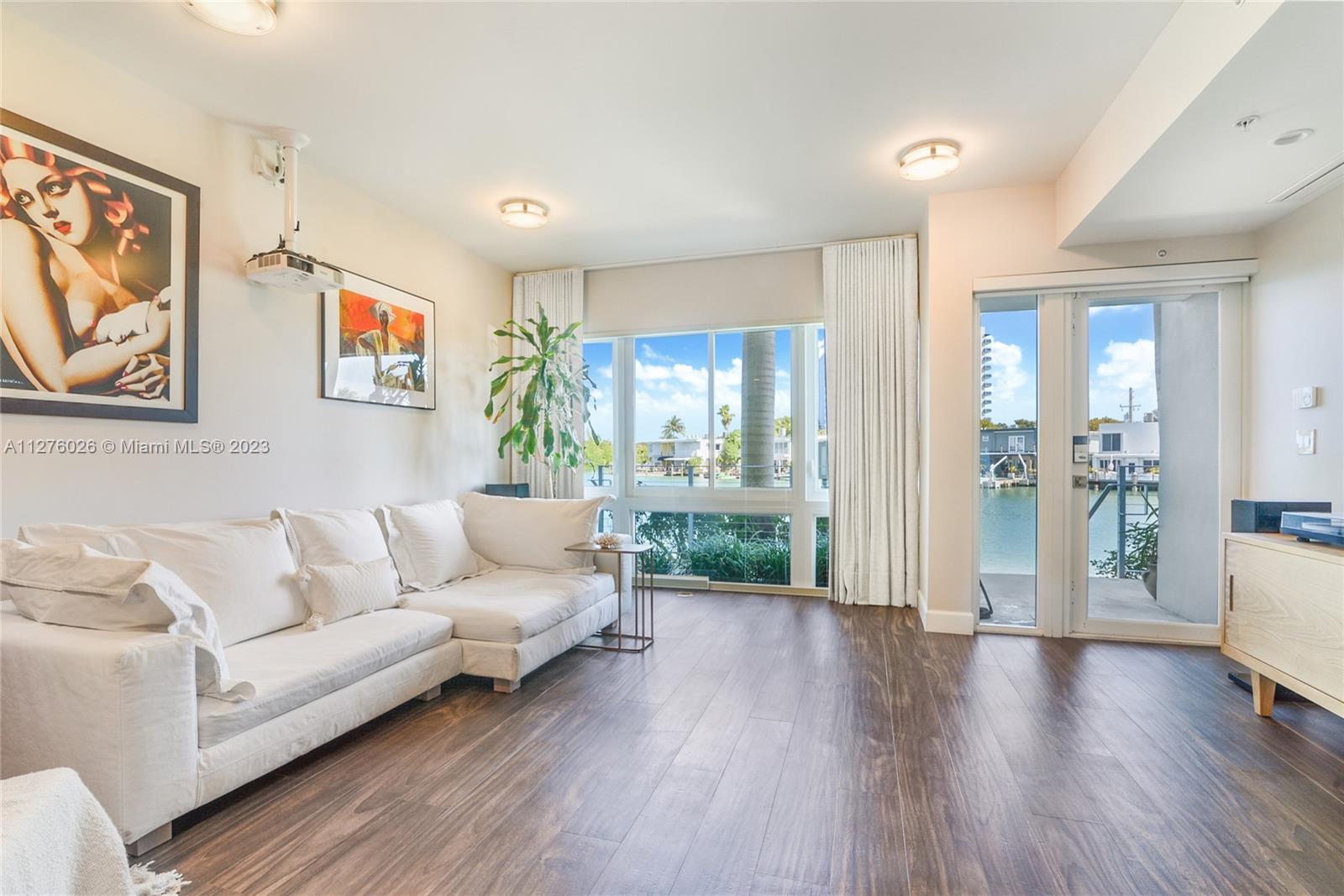 Spectacular Luxury Waterfront Townhome with Deeded Boat Dock and Lift. This 2015 Modern 4bed/4.5bath gem with 2022 upgrades features a Private Rooftop Terrace with Summer Kitchen and Intracoastal Turquoise Water Views, Lounge with cinema/entertainment system, private elevator, 2 car garage, EV Fast Charger, Savant Smart Home system, DICA Kitchen, Miele appliances, Cafe refrigerator. Italian ceramic floors, and California Closets. Water purification, and softener, wind sensor retractable awning. Hardwired internet, Nest, Ring security. Normandy Shores boasts a golf course, tennis courts, children's playground, outdoor gym and clubhouse dining. Iris On The Bay is a few blocks to the beach, dining and shopping.