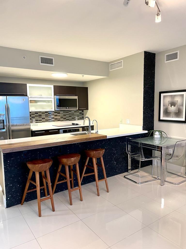 One of a kind 2 bedroom 2 bathroom at the Ivy. Current owners lived in the unit so they updated and customized it with quality interiors and furnishings. Tastefully furnished and stunning NW views of Miami and its sunsets. The parking spot is the best one in the building.