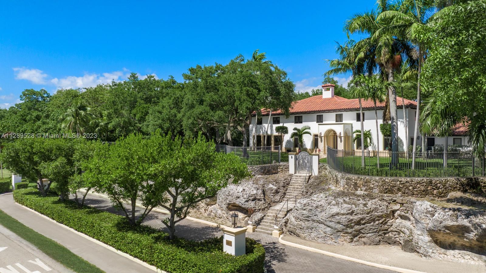 Indulge in the luxurious charm of this landmark estate in the heart of Coconut Grove. This 9,534 sq ft Mediterranean revival villa on a 40,000+ sq ft lot boasts smart home tech and an elevator, fully renovated in 2015. Enjoy breathtaking views of mature oak trees and manicured grounds through large windows while relishing in modern finishes and refined interiors. Step inside to find a grand foyer with marble & stone details, high ceilings, an updated open kitchen, and formal dining room with floor to ceiling glass. 7 spacious bedrooms, each with en-suite bath, including a primary suite, embody luxury and modernity. Conveniently located garage with staff quarters and laundry room complete this dream home.